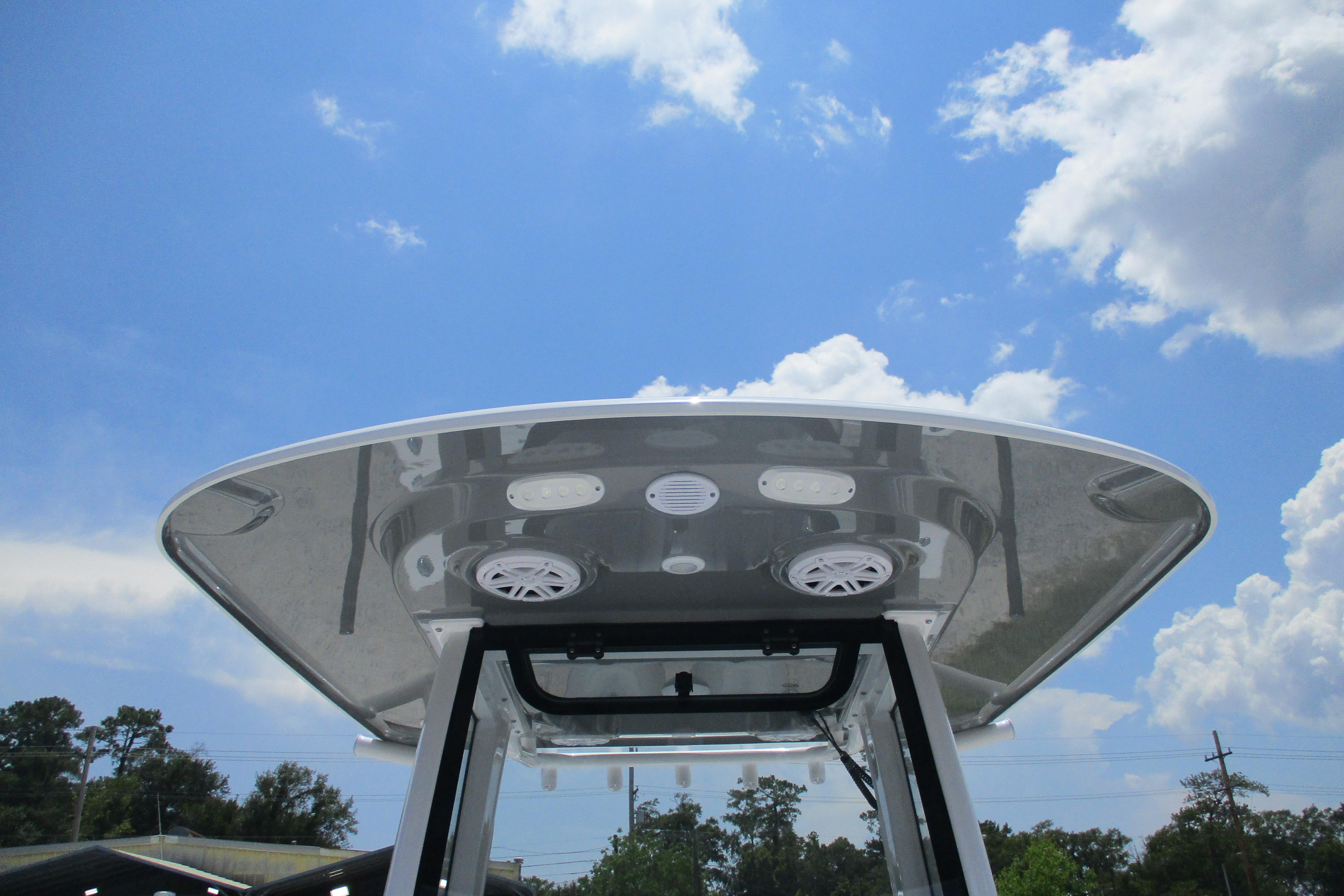 2027 Sportsman Open 252 Center Console boat T-top against a blue sky.