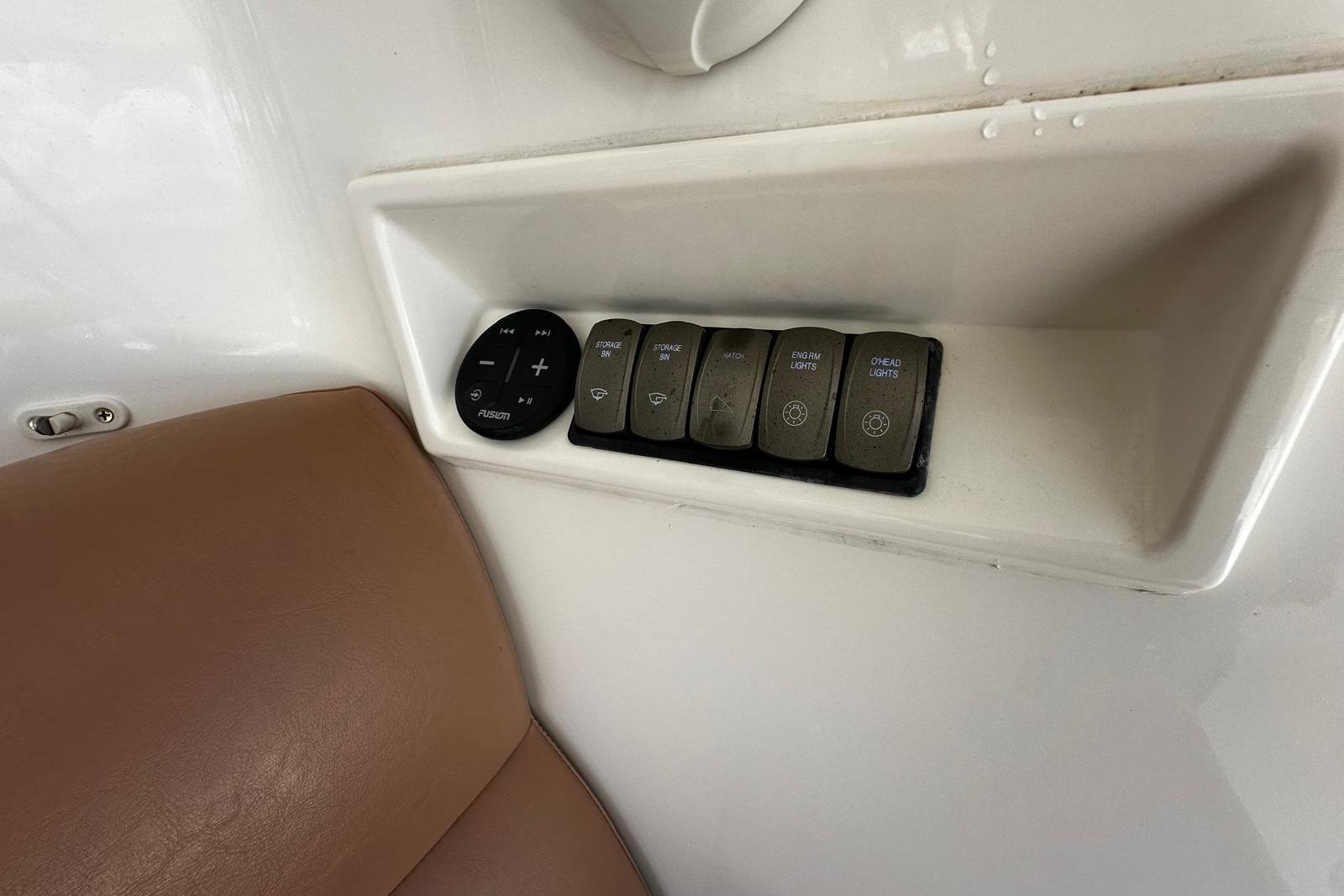 Control panel on 2012 Riviera 43 Flybridge with buttons and leather seating.