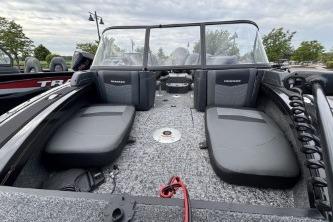 2026 Tracker Targa V-18 Combo boat interior with seating and windshield, under cloudy sky.