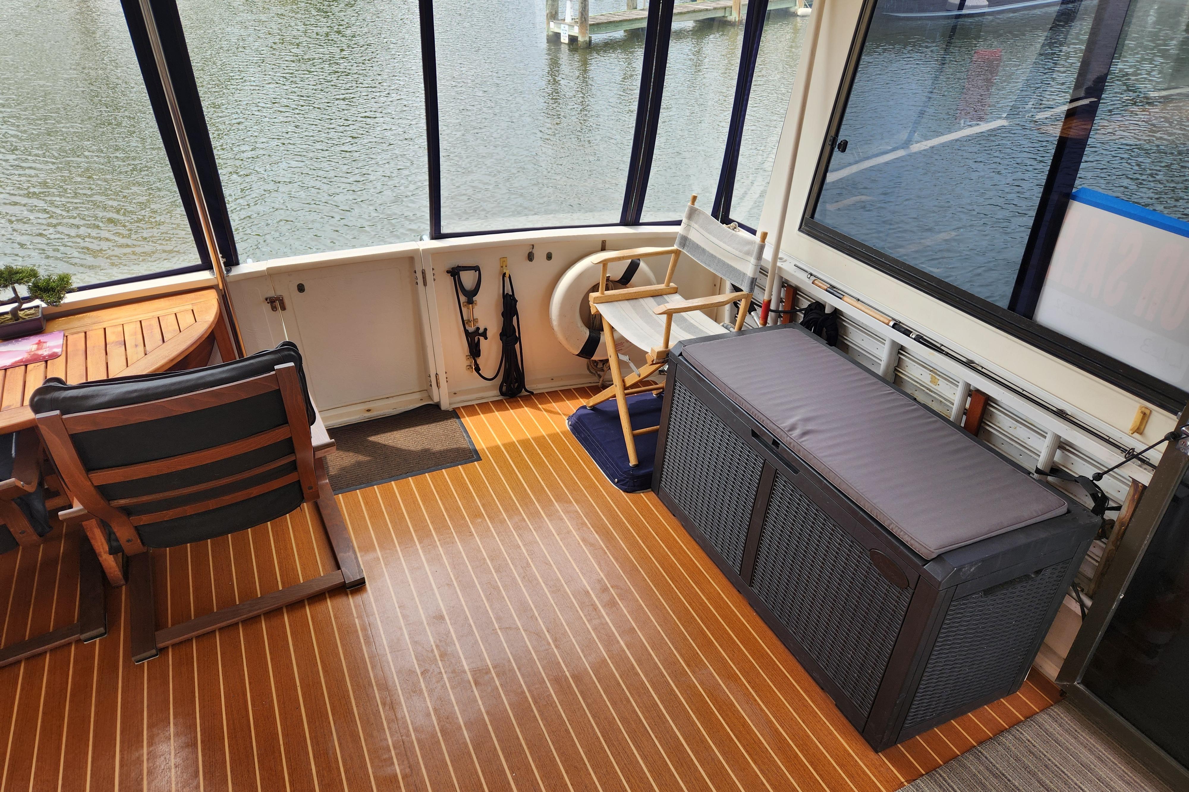 Interior of 1989 Hyatt Double Cabin Motoryacht with seating and storage, overlooking water.