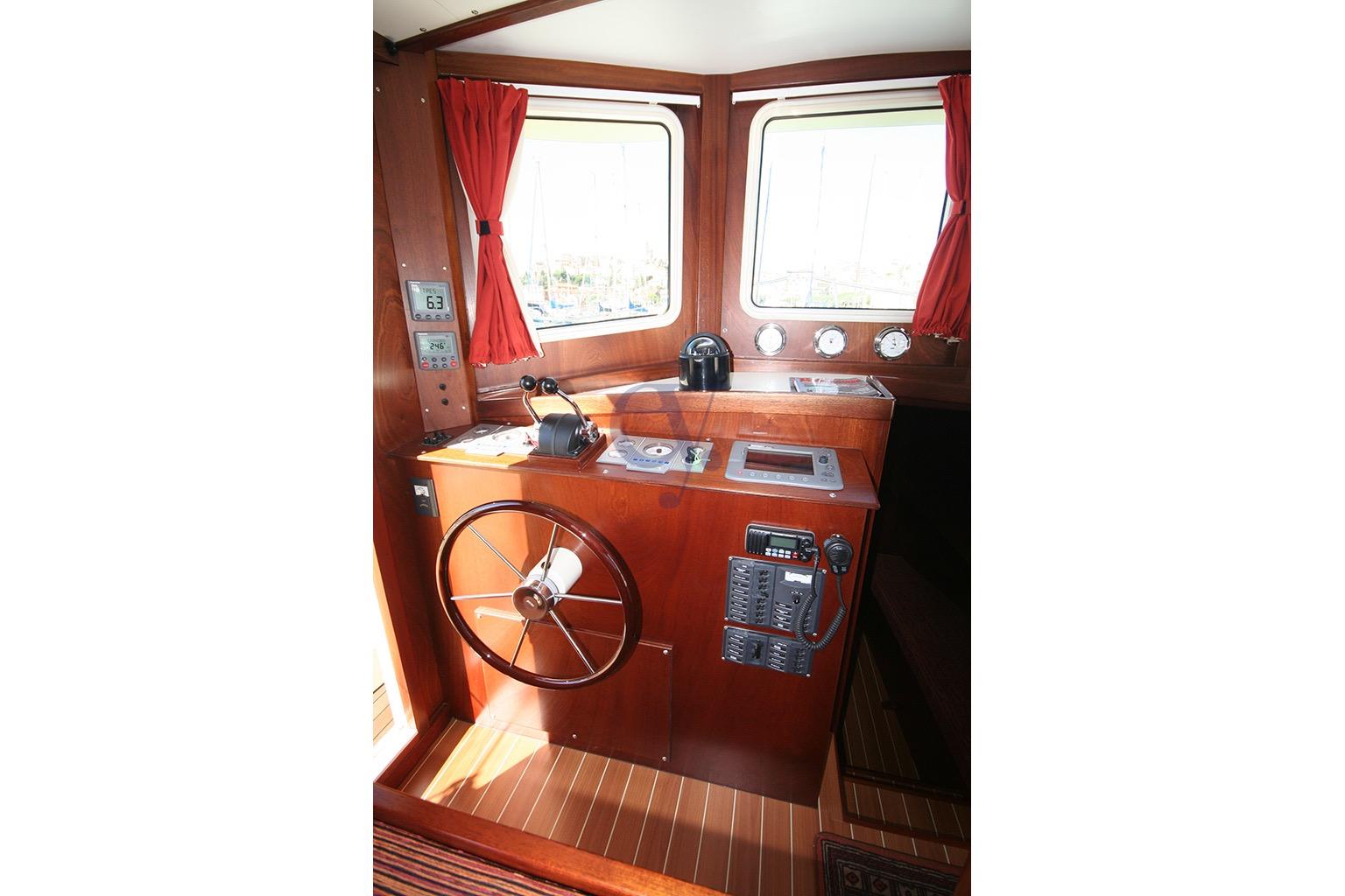 Pilot cabin of Sibma Navale Italiana Armstrong 12, 2012 model, featuring wooden interior and navigation equipment.