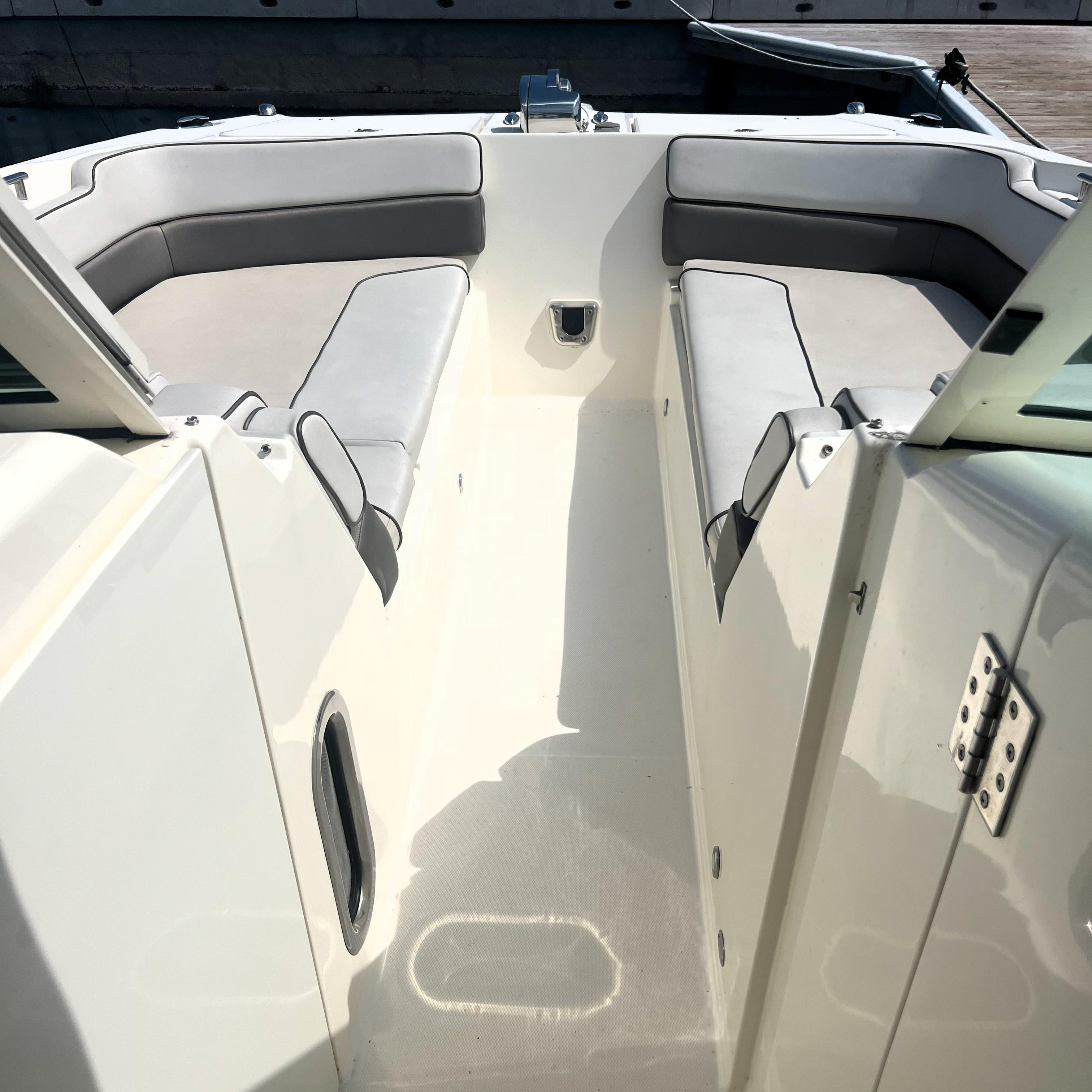 2016 World Cat 320 DC boat interior with cushioned seating and sleek design.