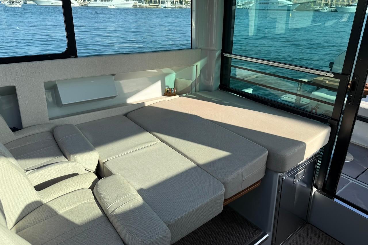 Interior of 2024 Saxdor 320 GTC yacht with comfortable seating and waterfront view.