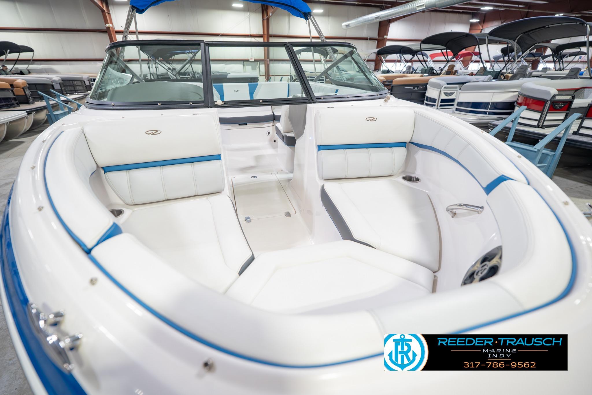 2015 Regal 2000 ESX Bowrider with white and blue interior, displayed in a showroom.