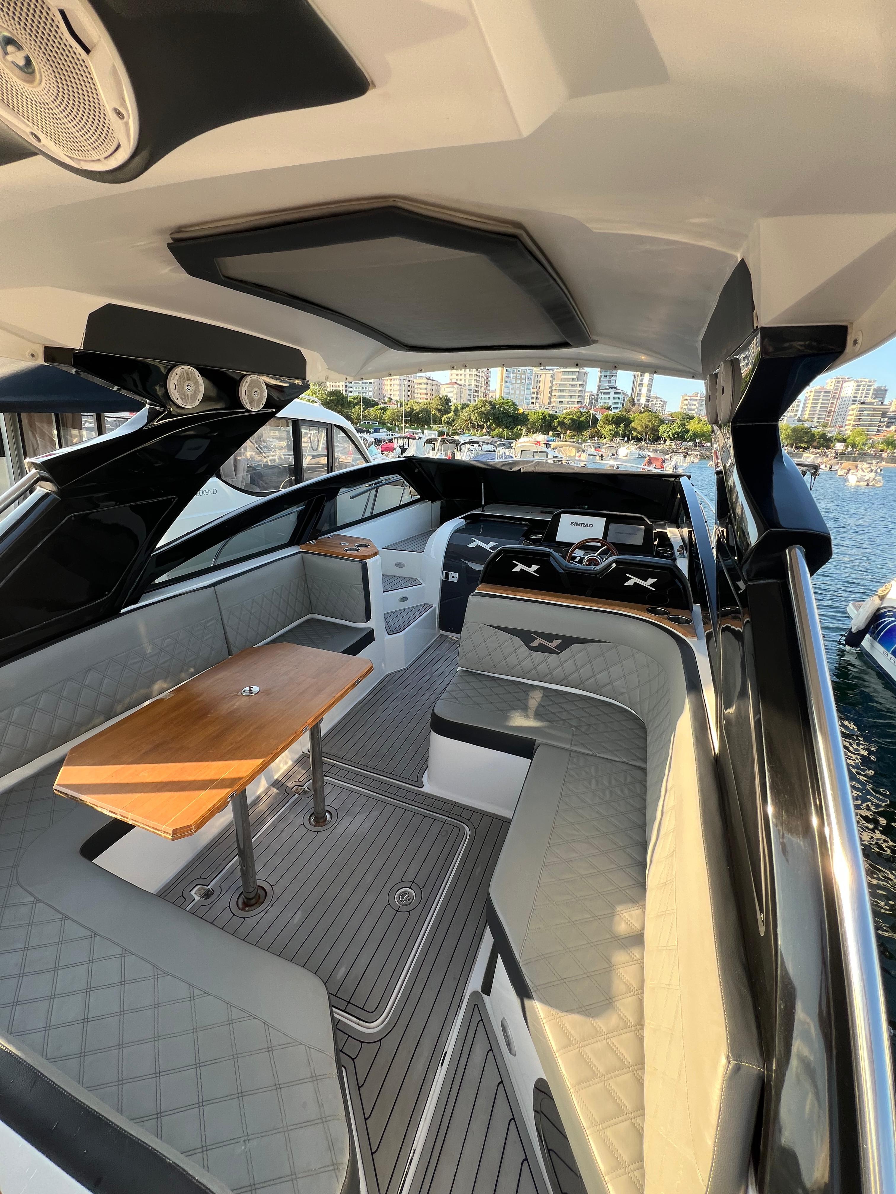 Interior of 2021 NX Boats 340 Sport Coupe, featuring sleek seating and modern design.
