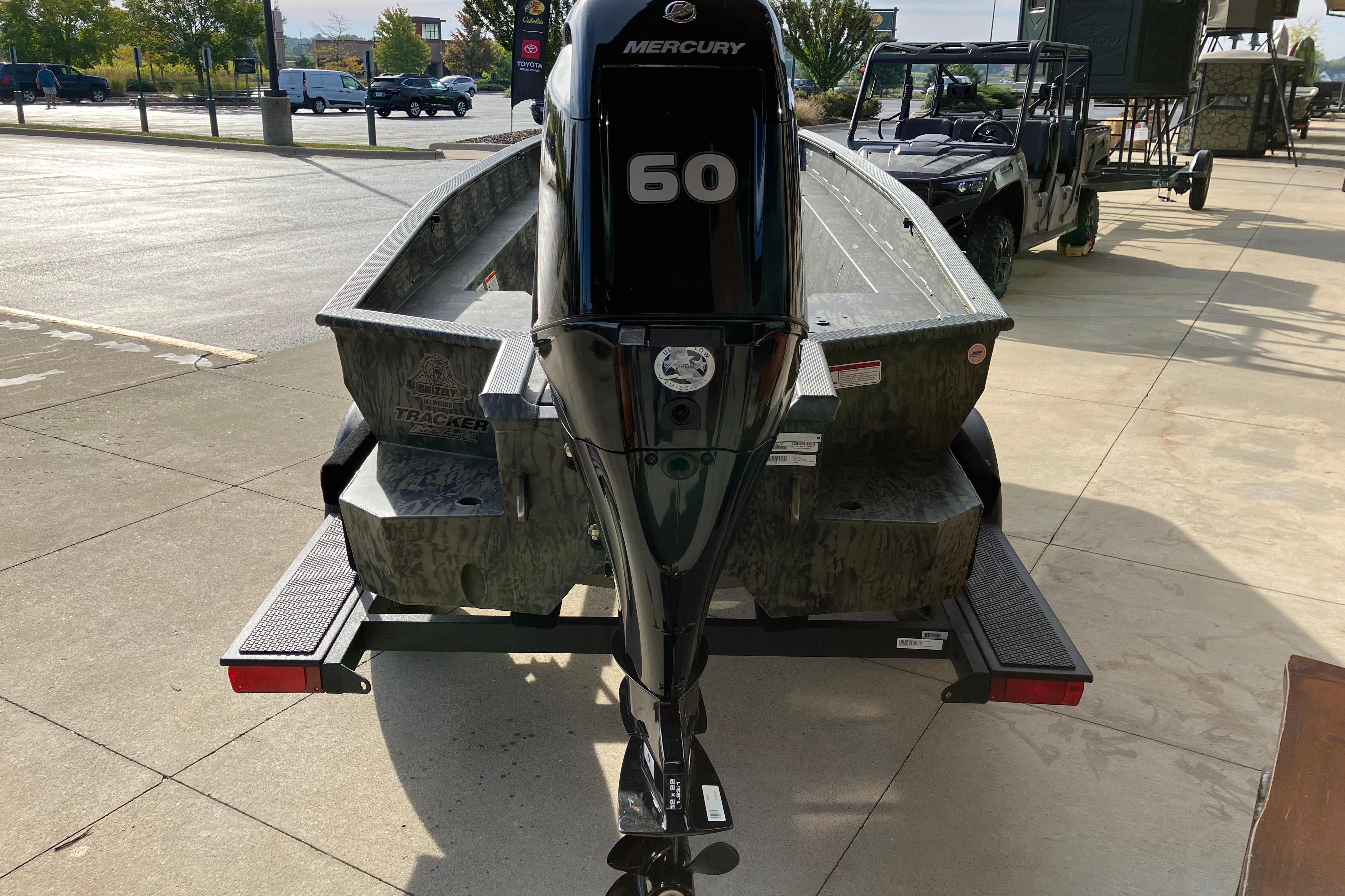 2026 Tracker Grizzly 1650 T Prairie Wings Edition boat with Mercury 60 engine on trailer.