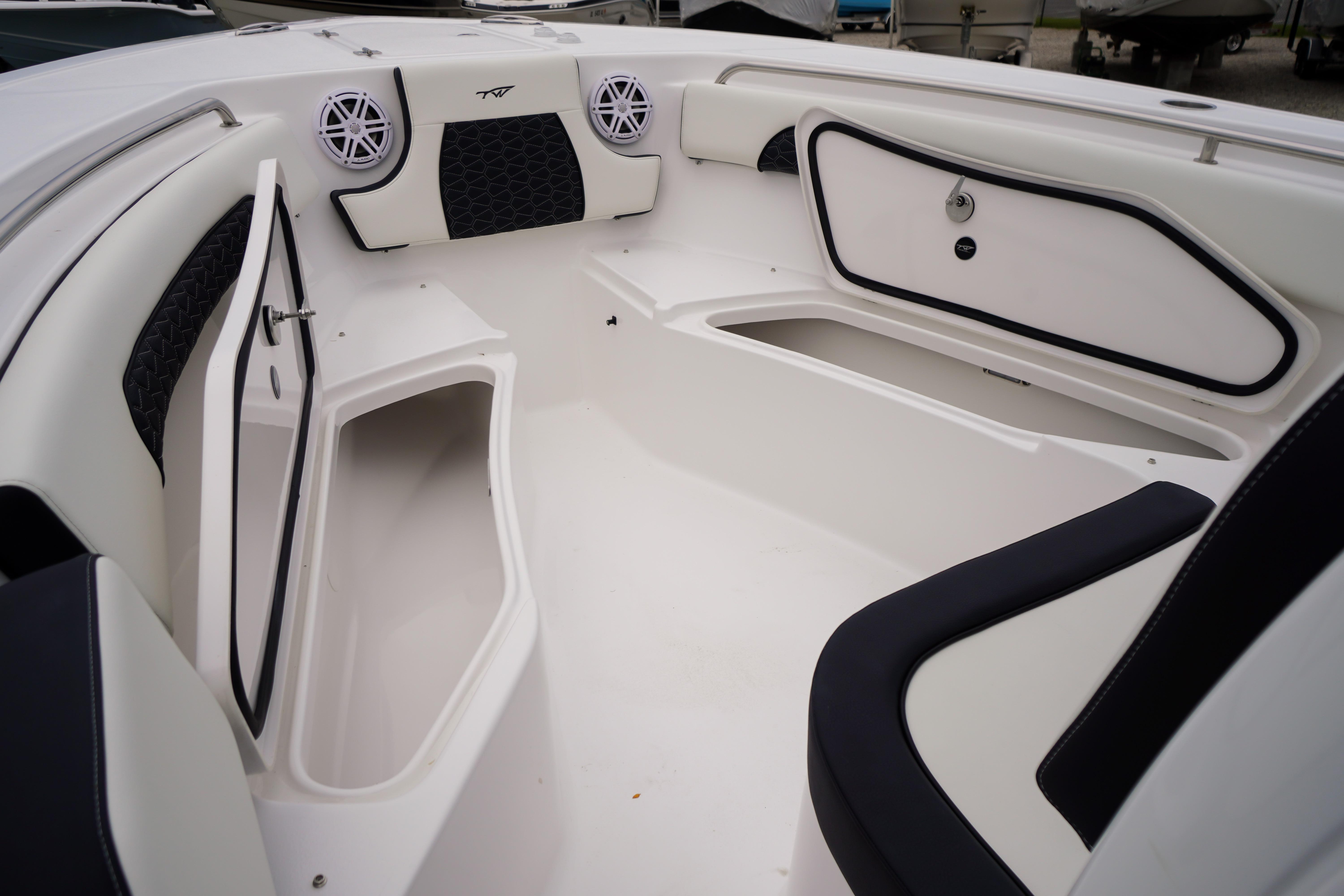 Interior of 2026 Tidewater 232 SS boat, featuring storage compartments and sleek seating.