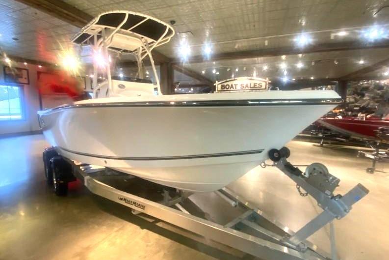 2024 Mako 214 Center Console boat displayed indoors on a trailer.