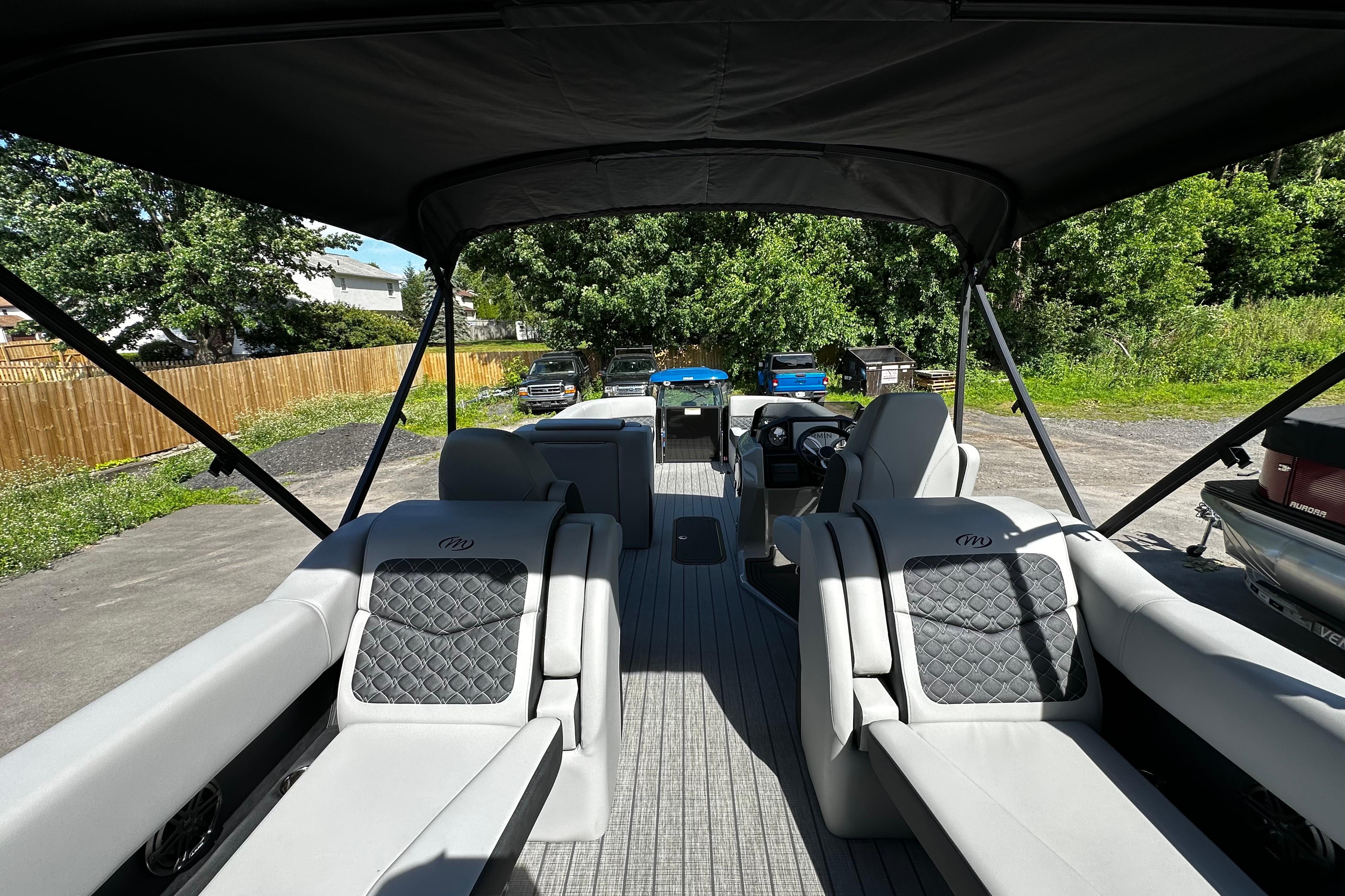 2027 Manitou 25 Encore RF pontoon boat interior with luxurious seating and canopy.