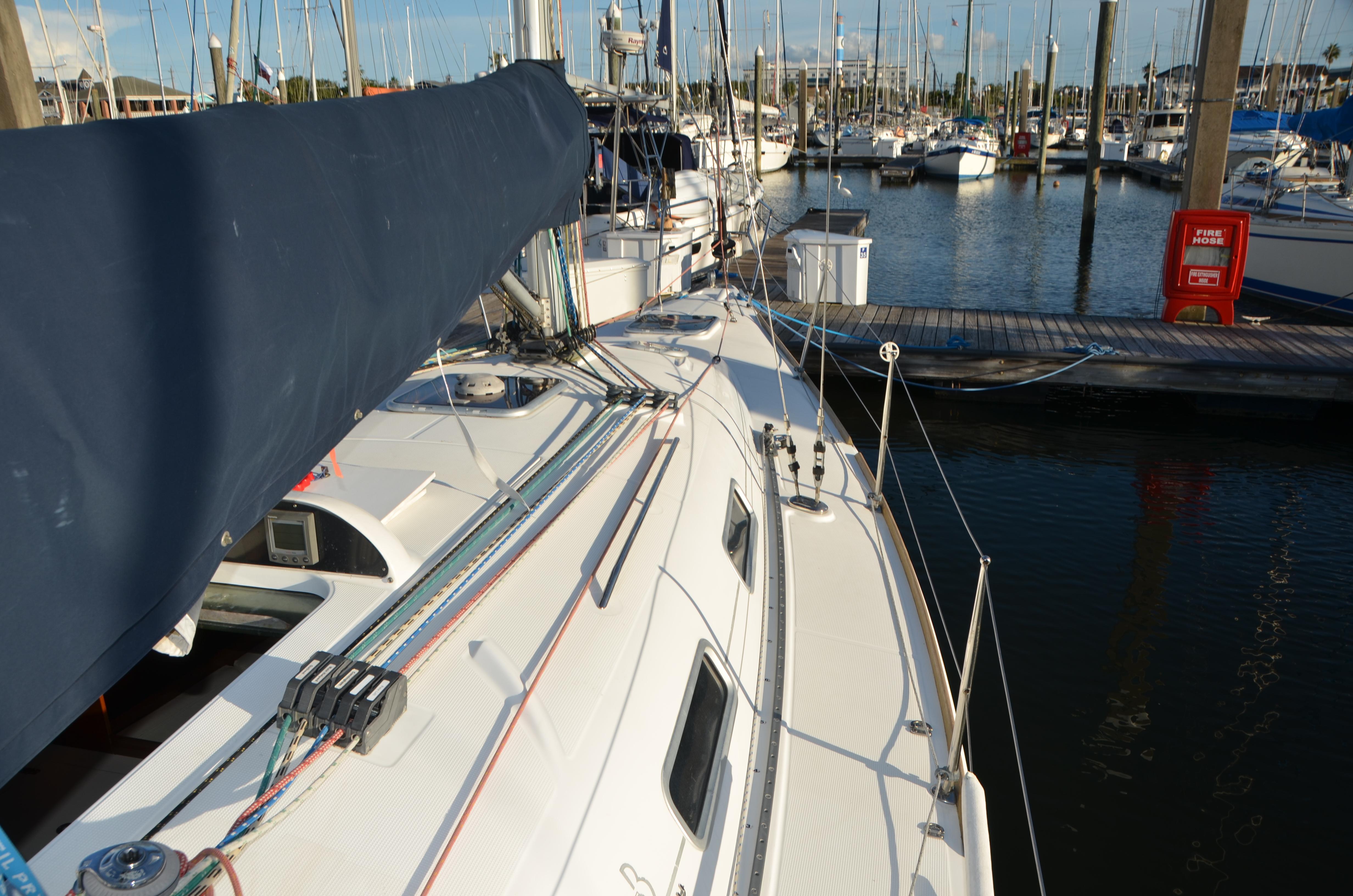 2002 Beneteau First 36.7 sailboat docked in a marina, showcasing deck and rigging.