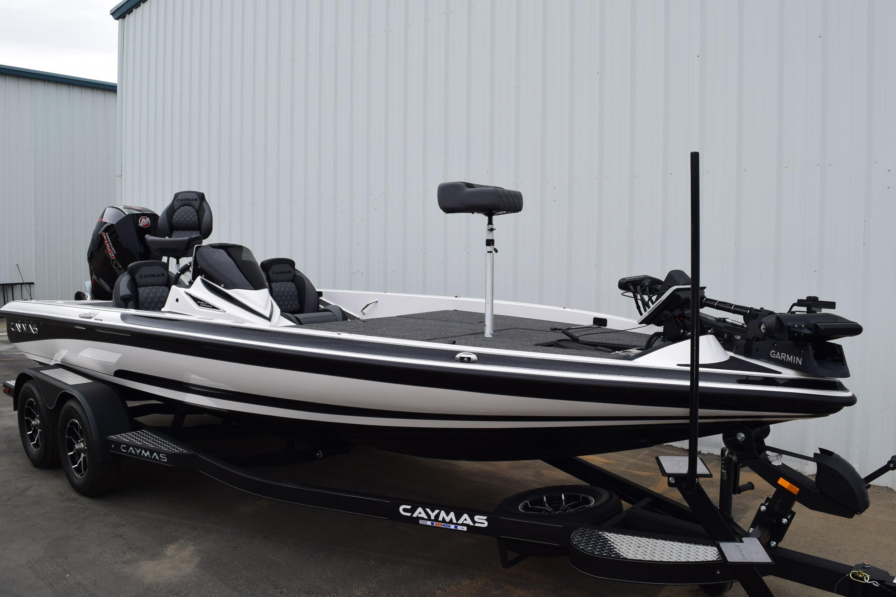 2027 Cayams CX 20 Pro fishing boat on trailer, parked near a building.