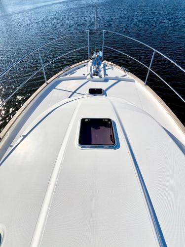 2025 Sabre 43 Salon Express yacht on calm water, showcasing sleek deck design.
