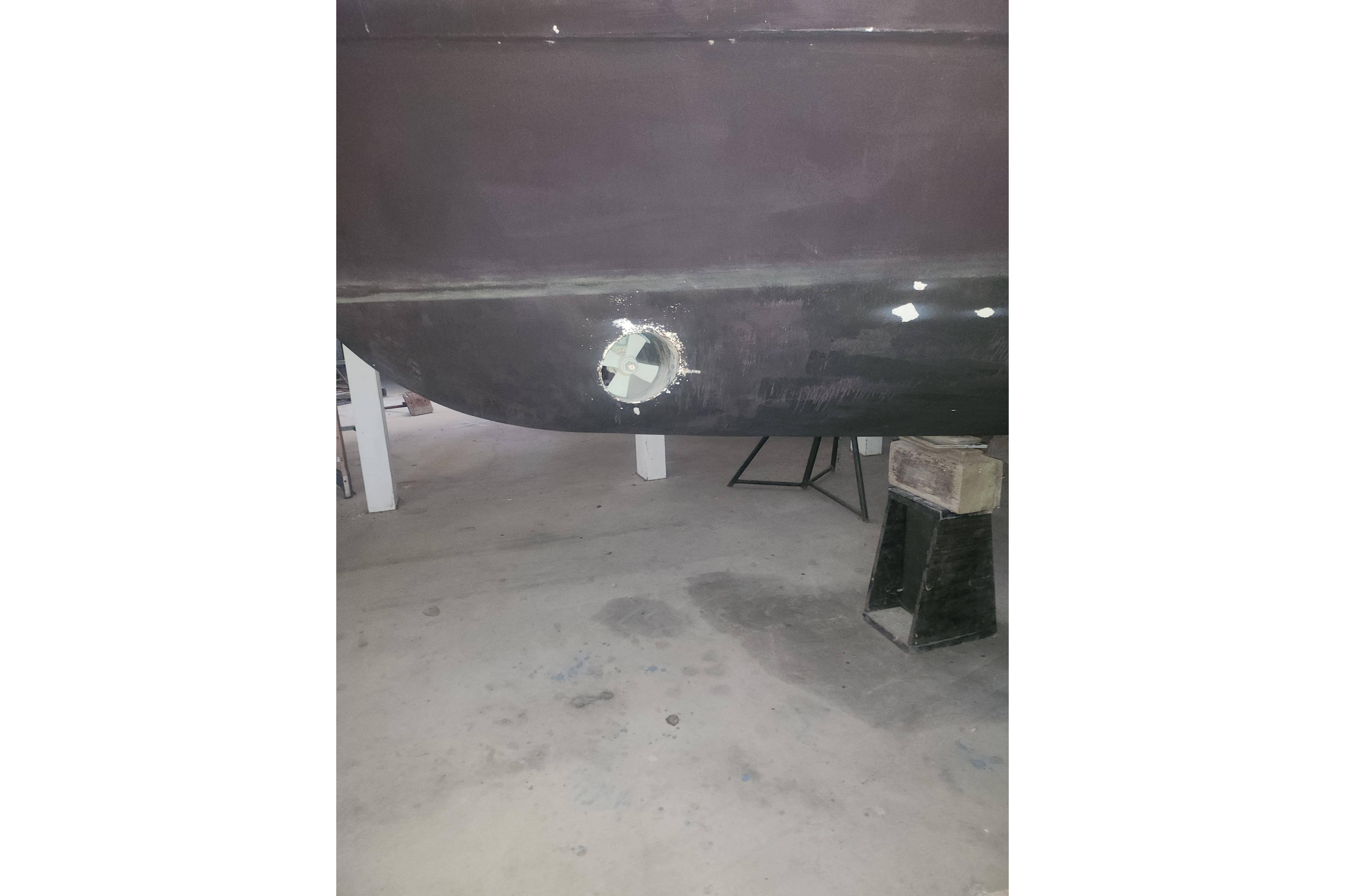 1997 Mainship 350 Trawler hull in dry dock, showing repair work.