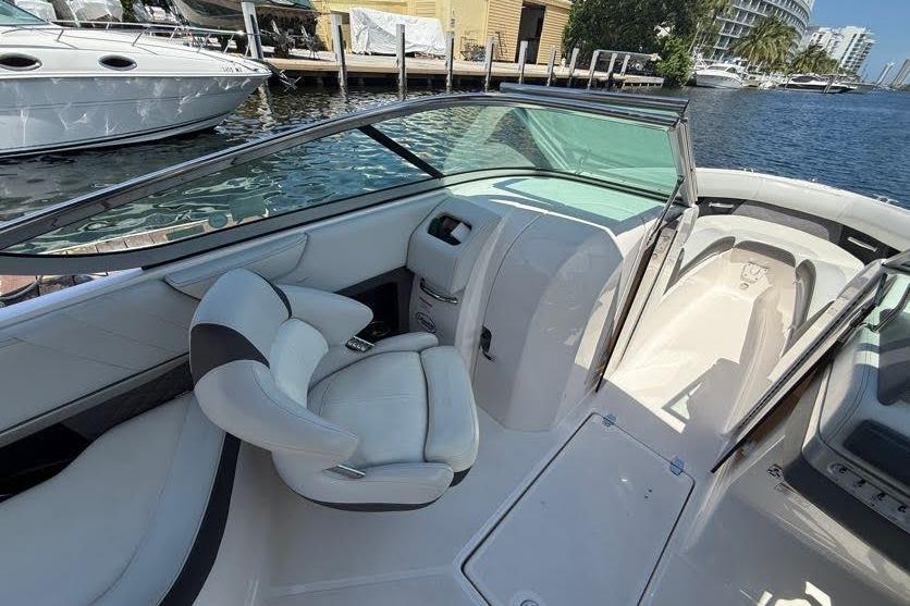 2014 Regal 2500 Bowrider interior with white seating, docked by waterfront.