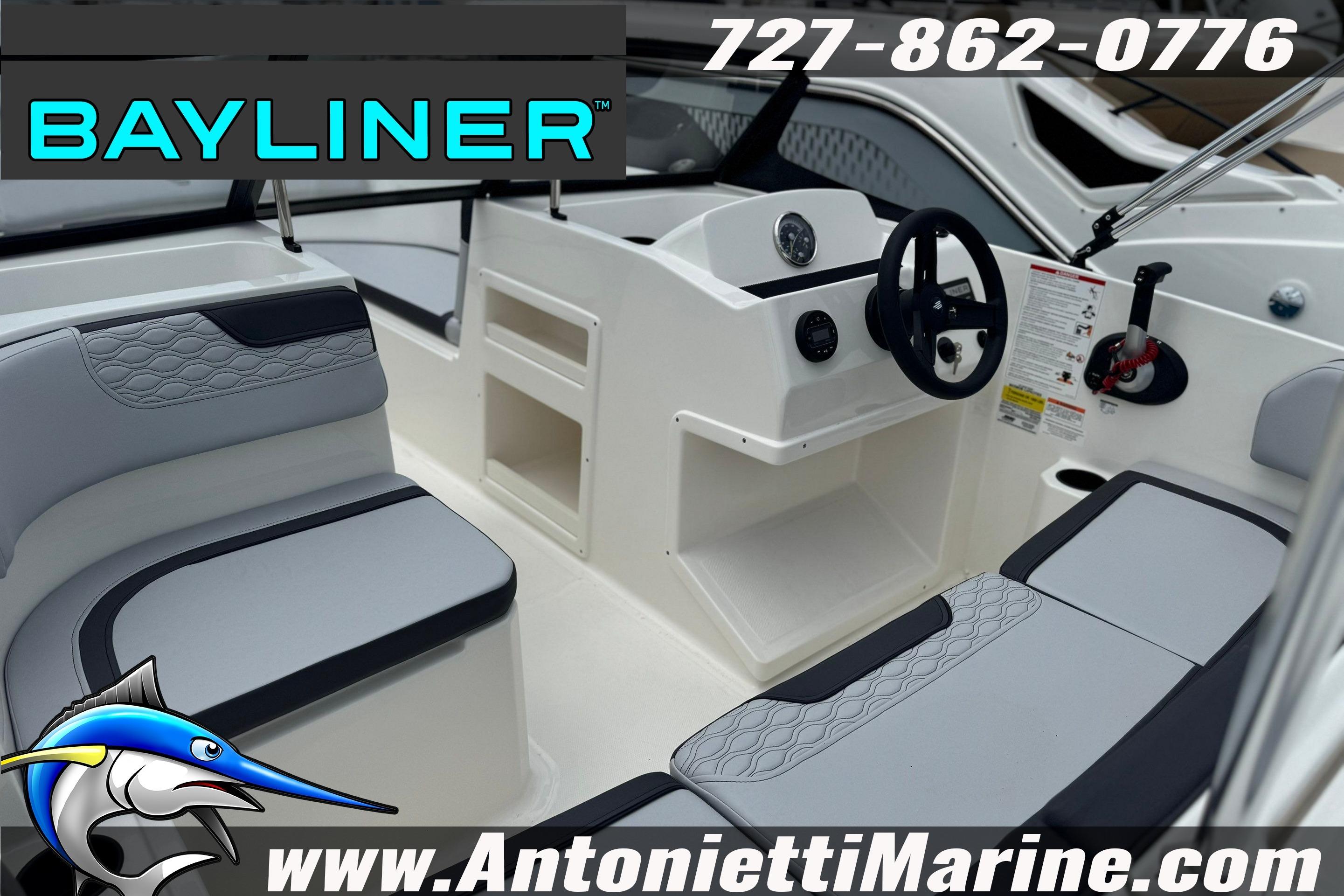 2026 Bayliner Element M17 boat interior with seating and steering console, featuring modern design.