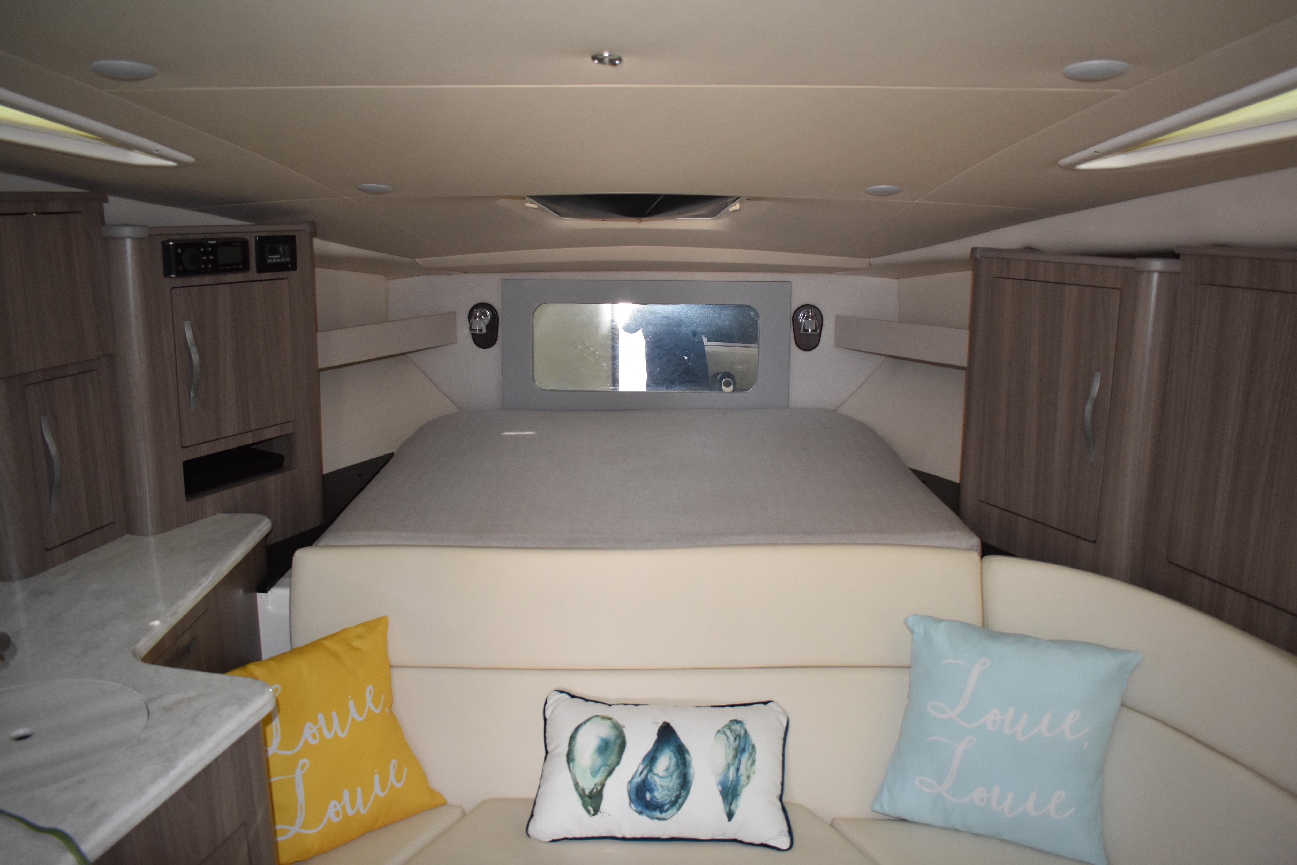 Interior of 2020 Regal 35 Sport Coupe with cozy bed and decorative pillows.