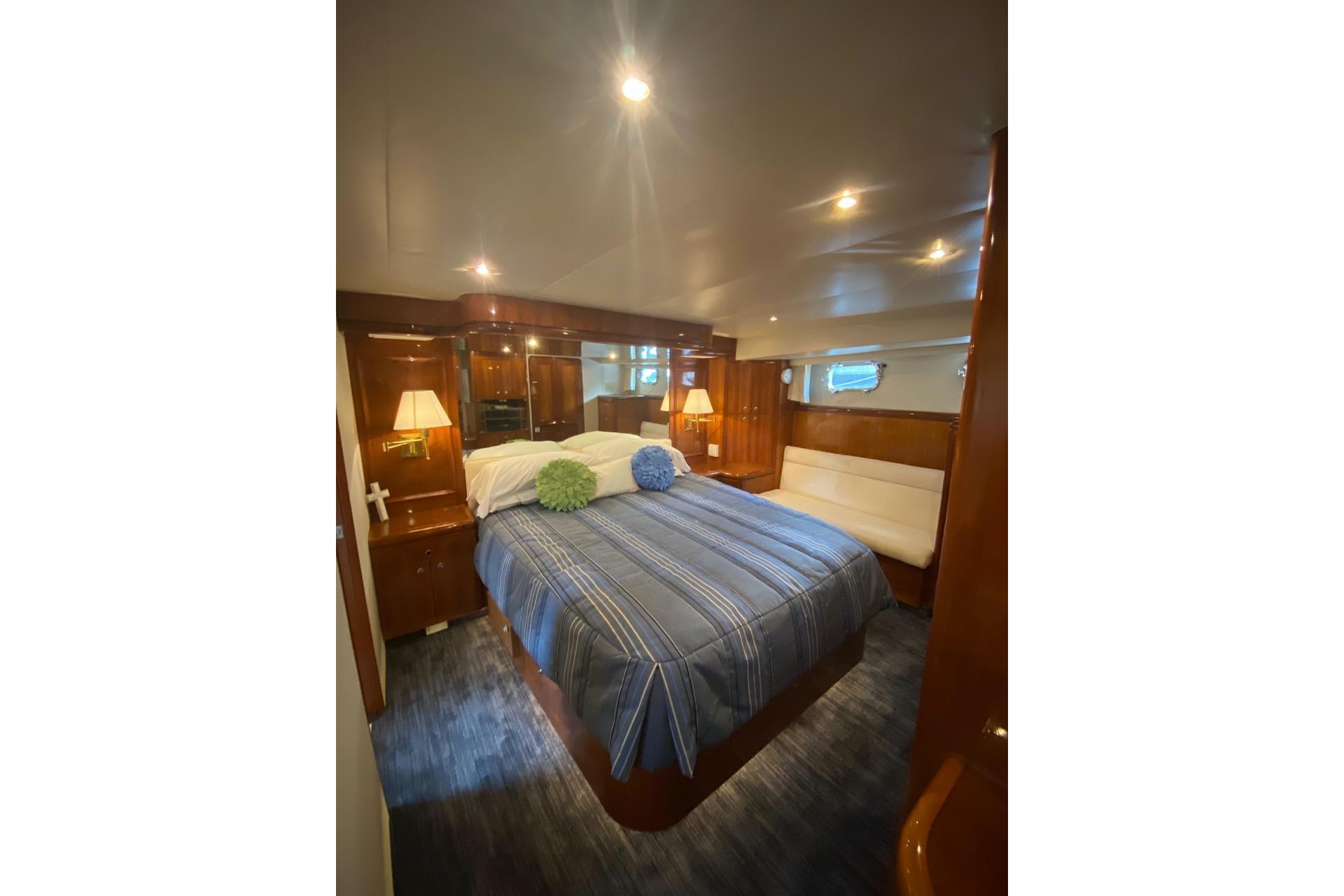 Luxurious bedroom interior of 2006 North Star Yachts 73 Cockpit Motoryacht with elegant wood finishes.