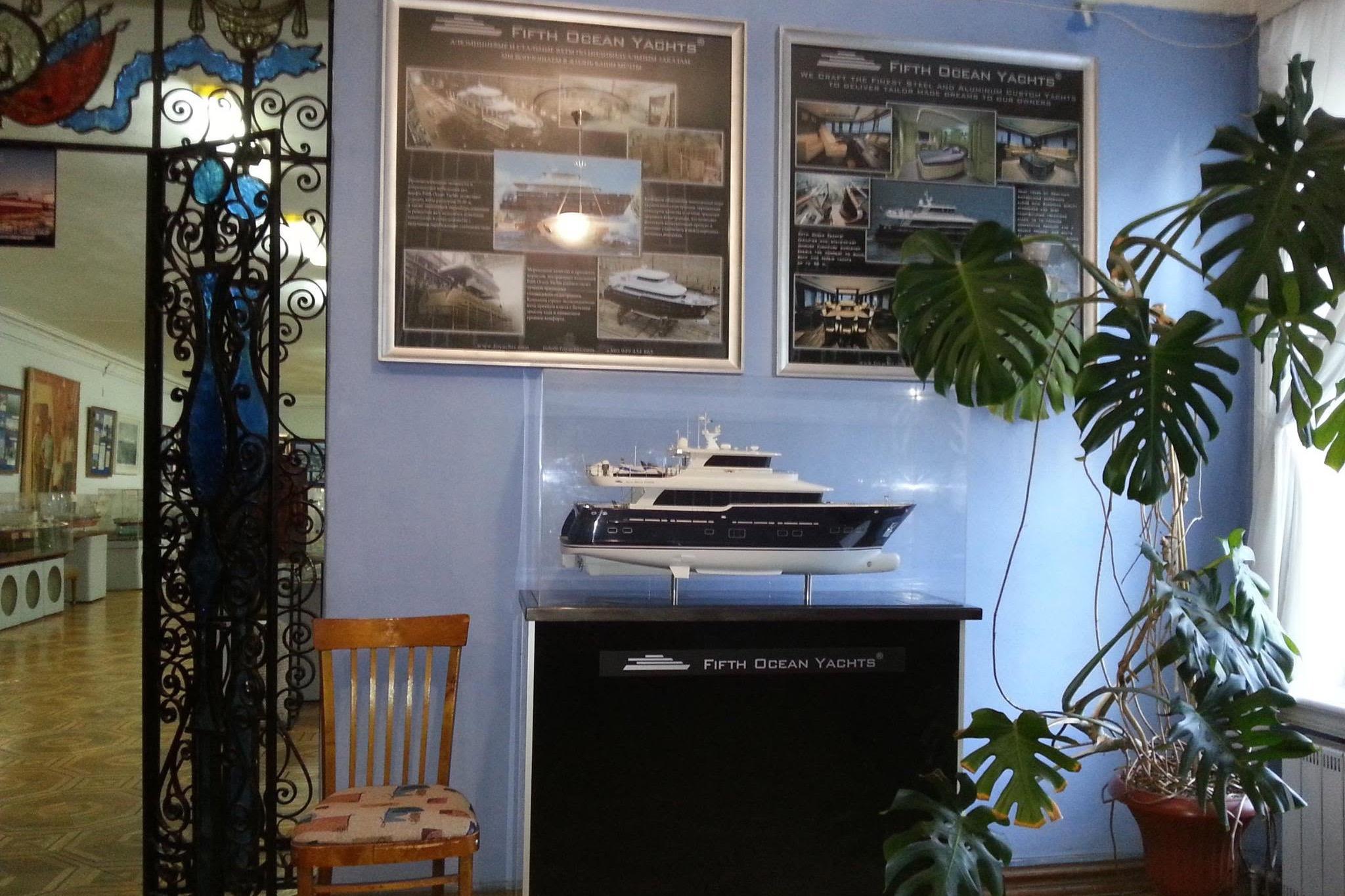 Model of Fifth Ocean Yachts 24m Displacement Explorer Yacht, 2014, displayed indoors with informational posters.