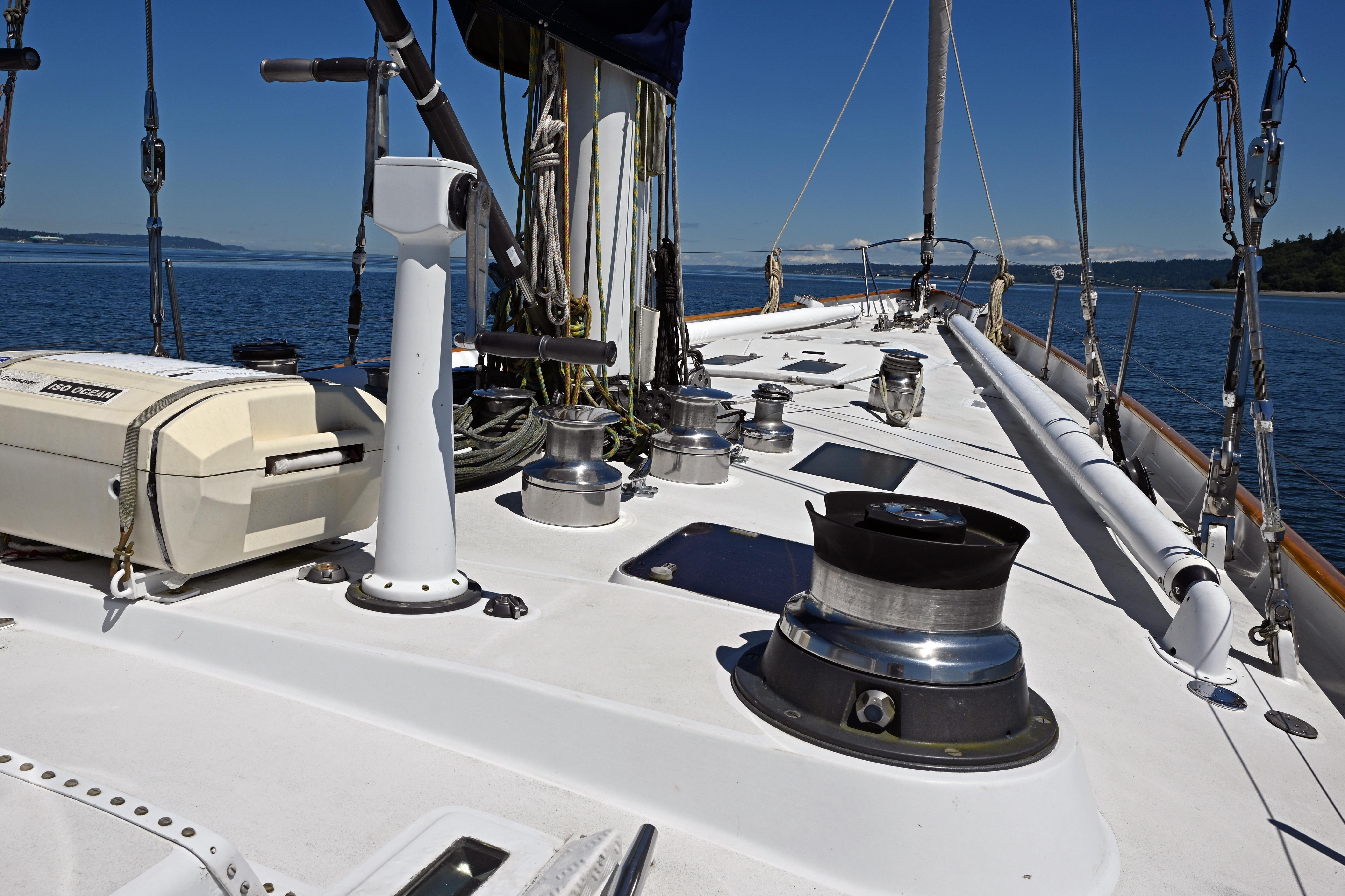 Deck view of 1968 Abeking & Rasmussen Tripp 74 yacht, featuring winches and ocean backdrop.