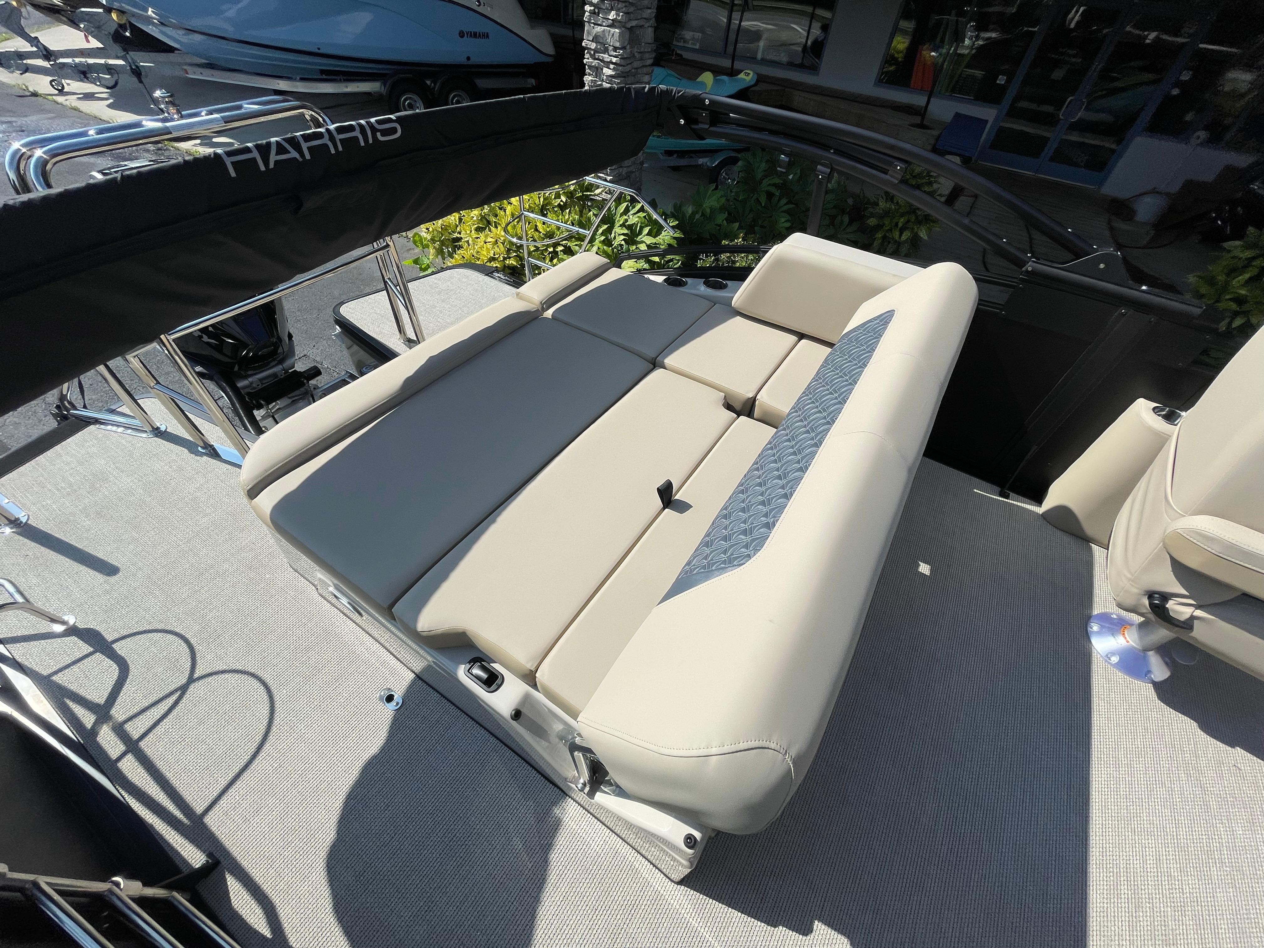 2026 Harris Solstice 230 boat interior with beige seating and modern design.