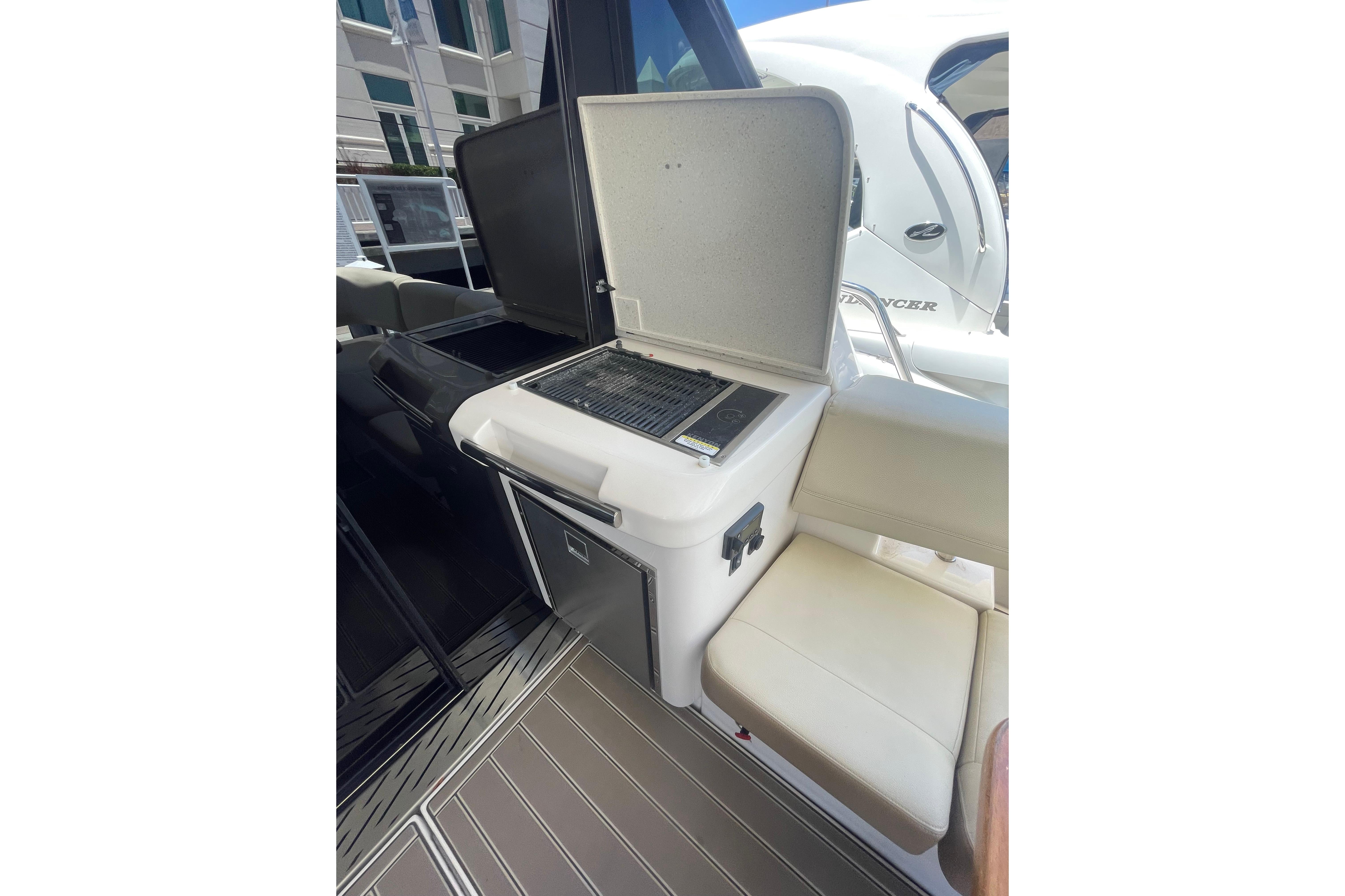 Outdoor grill and seating area on a 2020 Regal 42 Grande Coupe yacht.