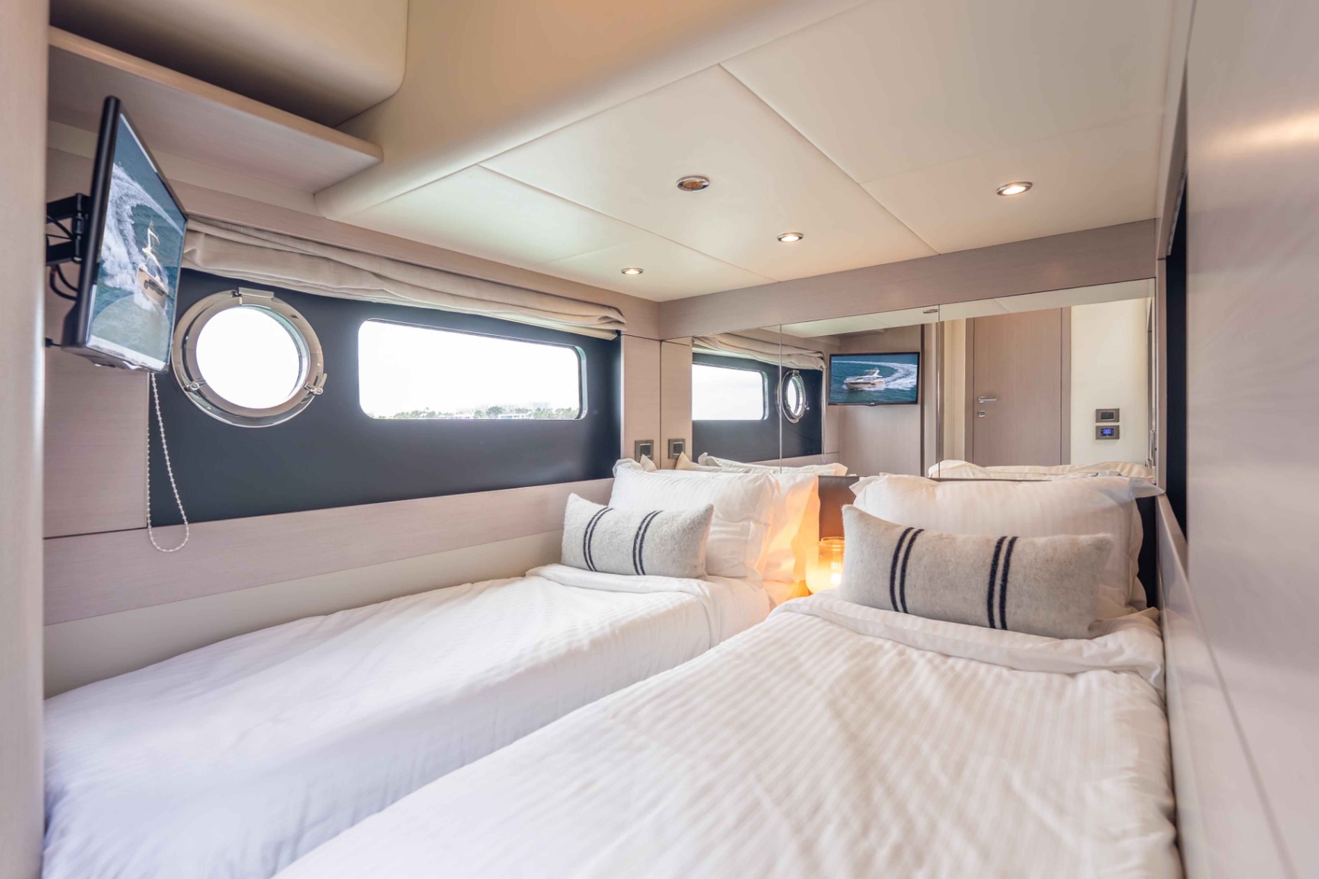 Luxurious cabin interior of 2019 Absolute 58 FLY yacht with twin beds and modern decor.