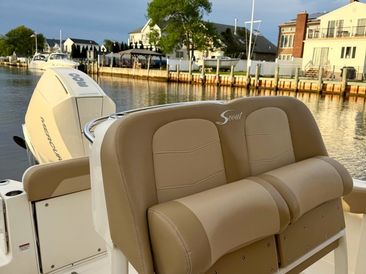 Scout 235 XSF 2020 boat with beige seating by the water.