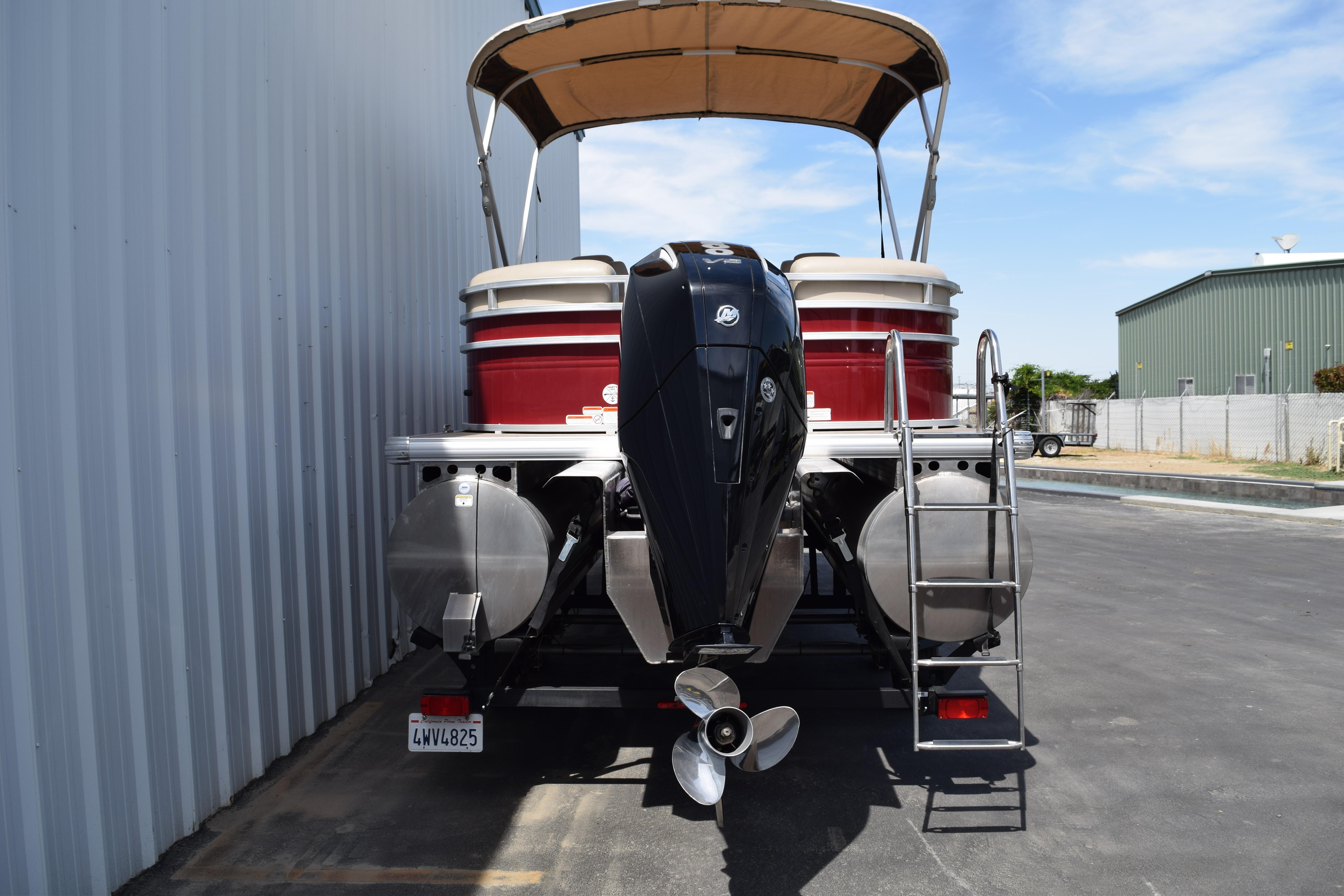2025 Sun Tracker Party Barge 22 XP3 pontoon boat with outboard motor and ladder.