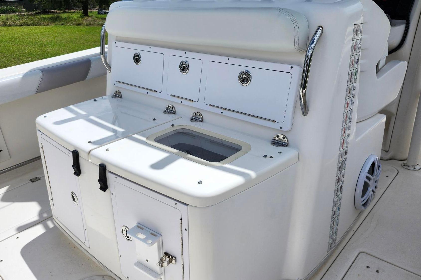2015 Robalo R300 Center Console boat interior with storage compartments and seating.
