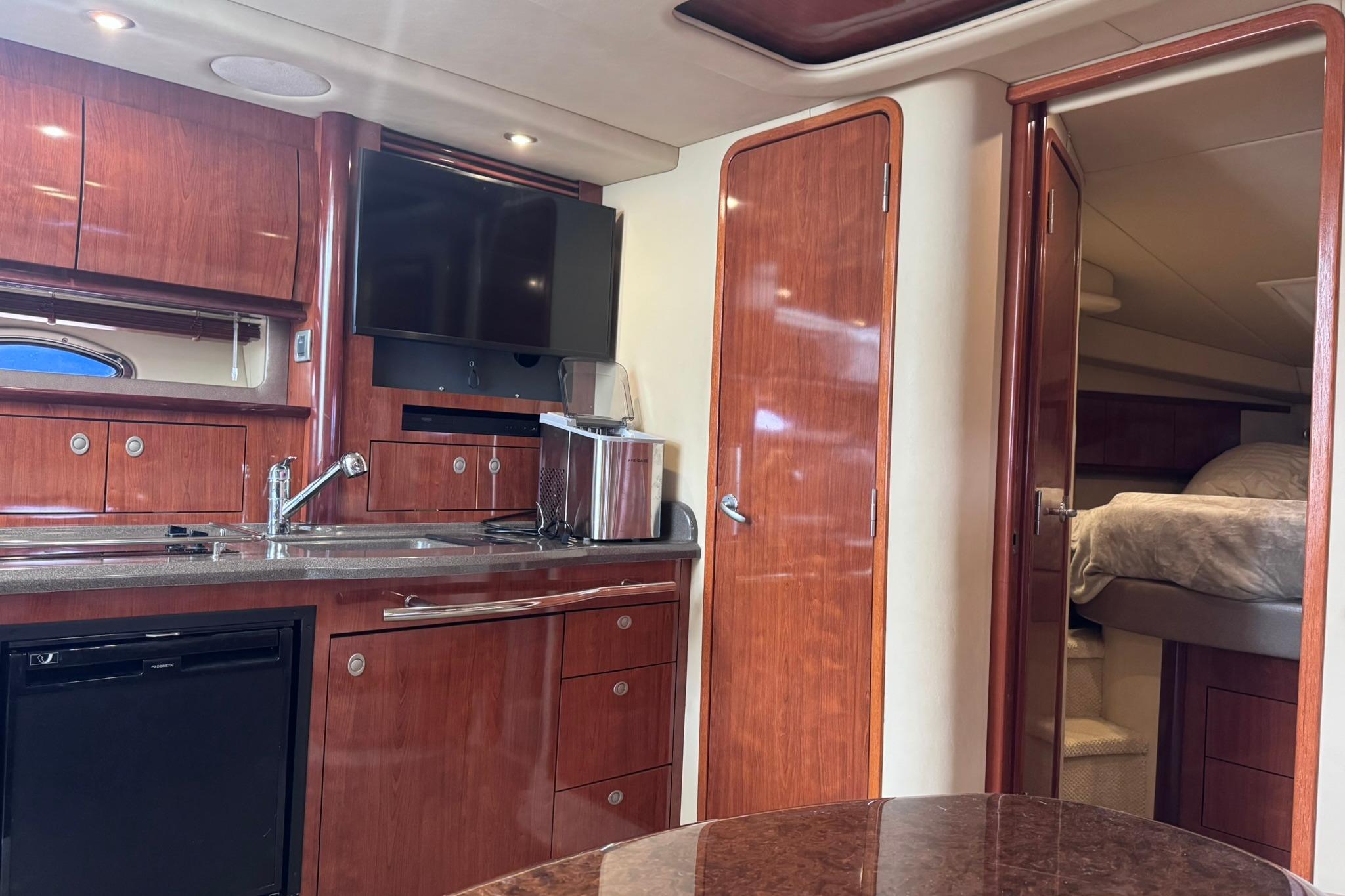 Interior of 2004 Sea Ray 390 Sundancer yacht with wood cabinetry and modern amenities.