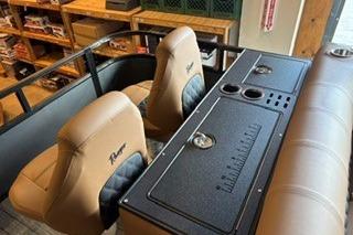 2026 Ranger 220FC boat interior with tan seats and storage console.