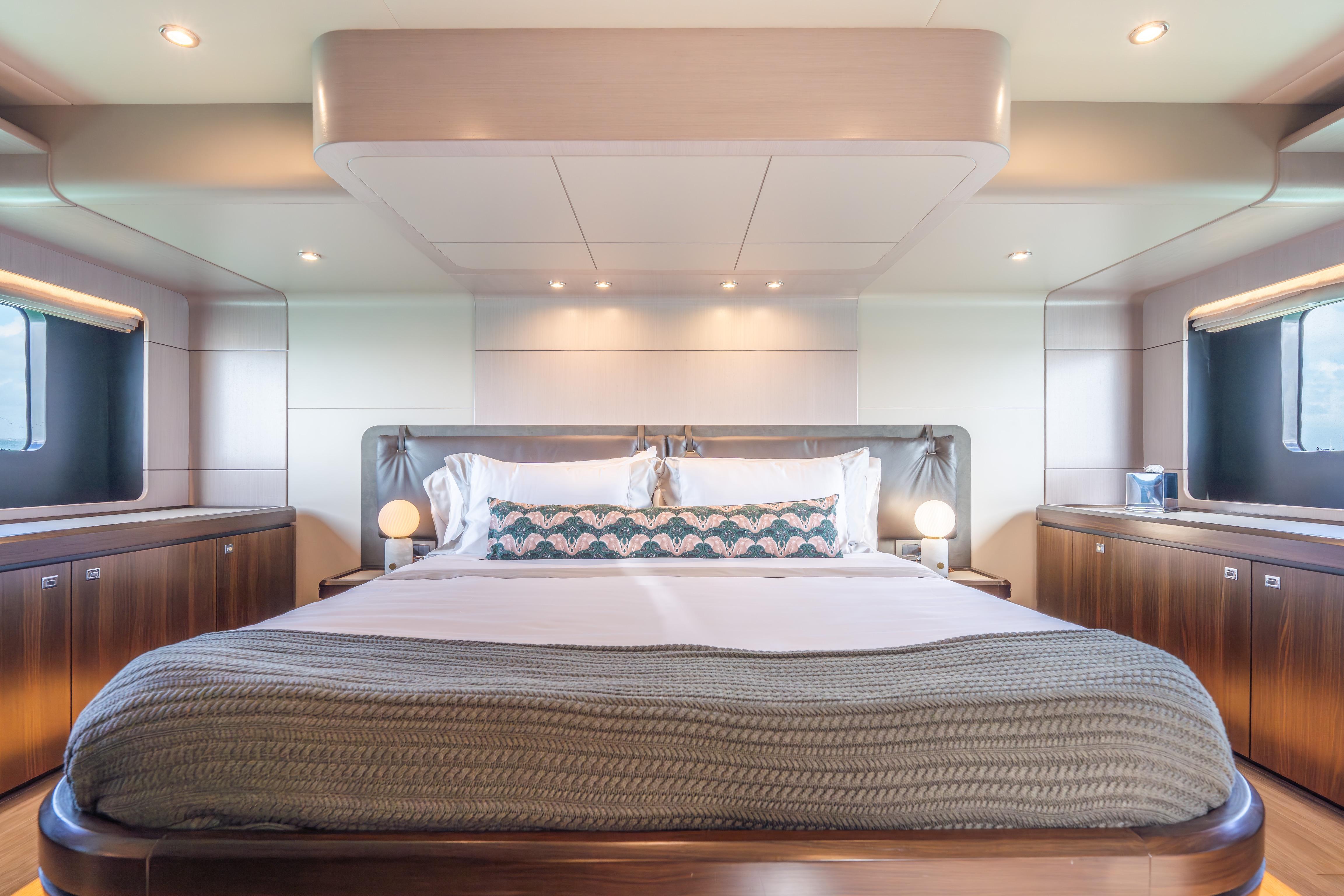 Luxurious bedroom interior of 2019 Absolute 58 FLY yacht with elegant design and ambient lighting.