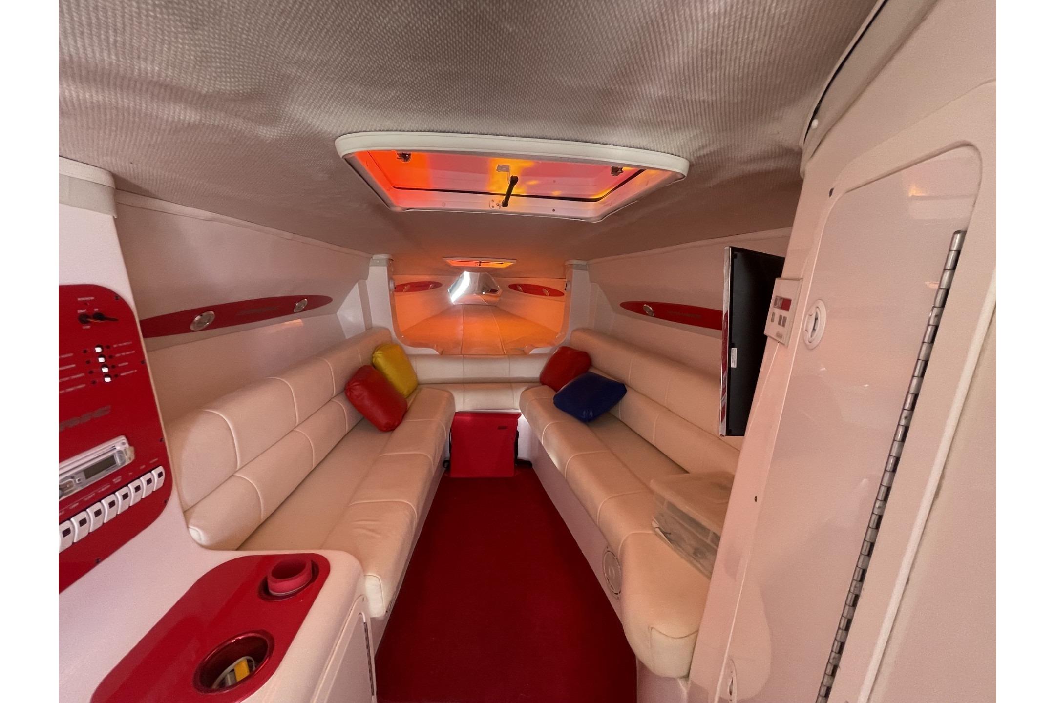 Luxurious interior of a 2006 Sonic 386 boat with plush seating and vibrant accents.