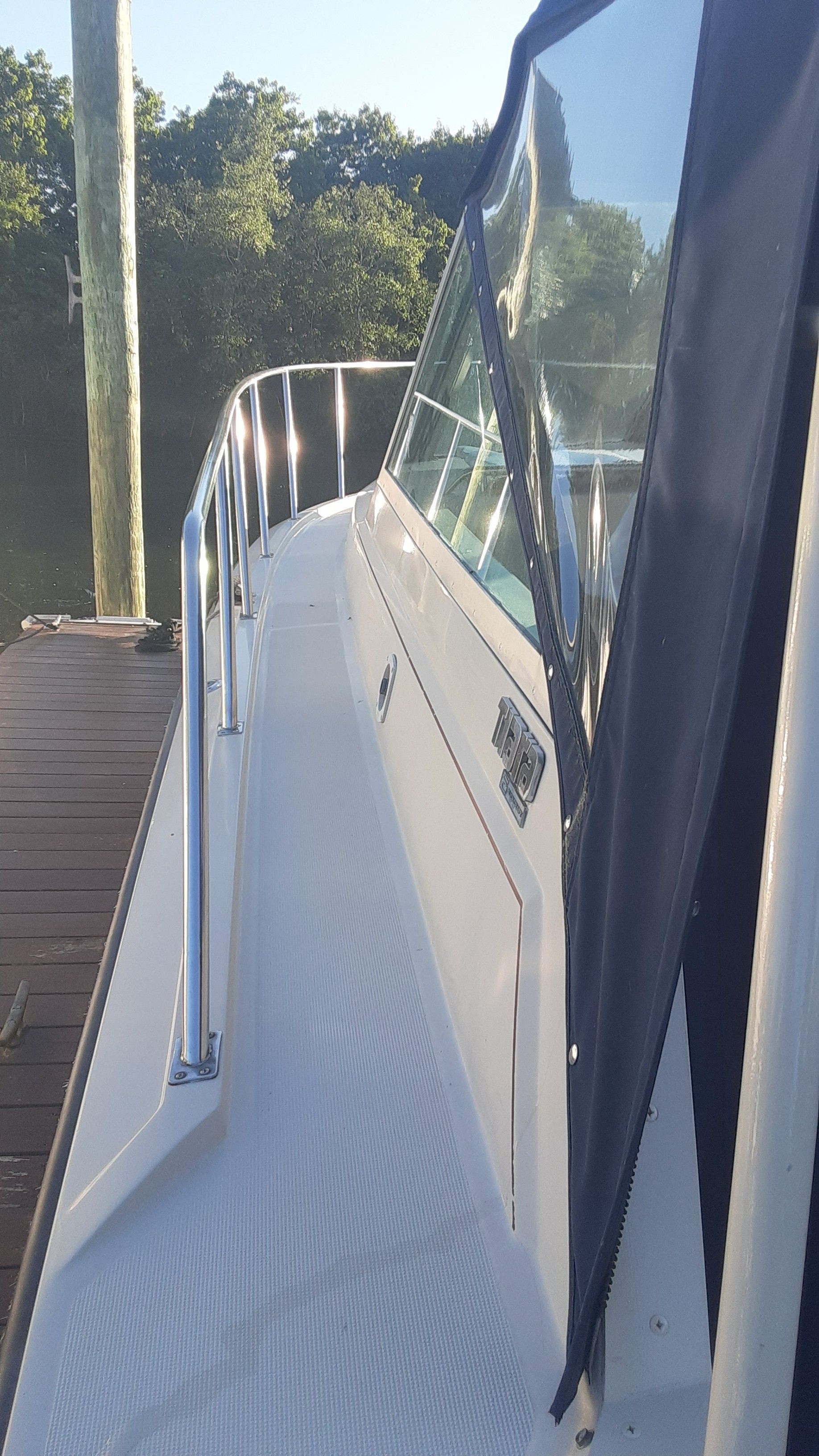 1985 Tiara Yachts 3100 Open at dock, side view.