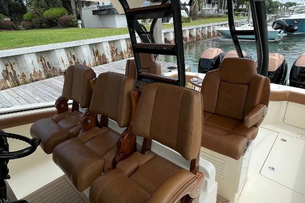Luxury seating on 2020 Scout 420 LXF boat, docked by the water.