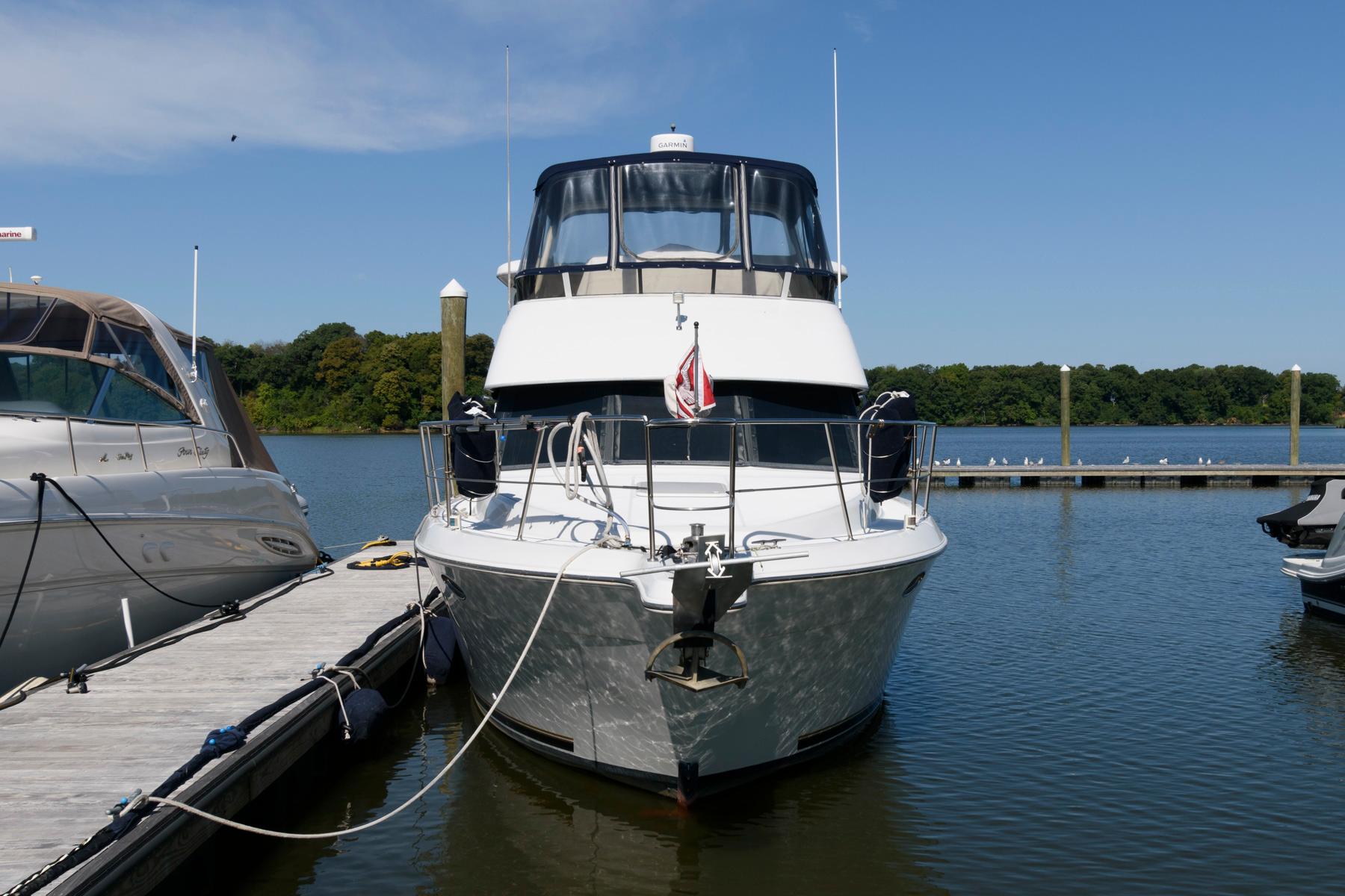 1997 Carver 400 Cockpit Motor Yacht docked at marina.