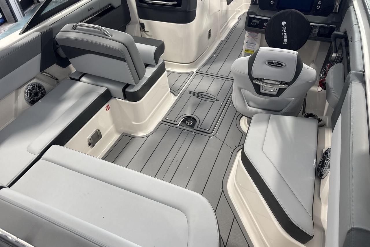 Interior of a modern boat with gray and white seating and flooring.