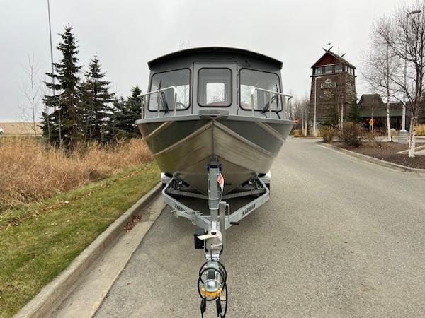2024 Spartan 220 Maximus boat on trailer, parked on a suburban street.