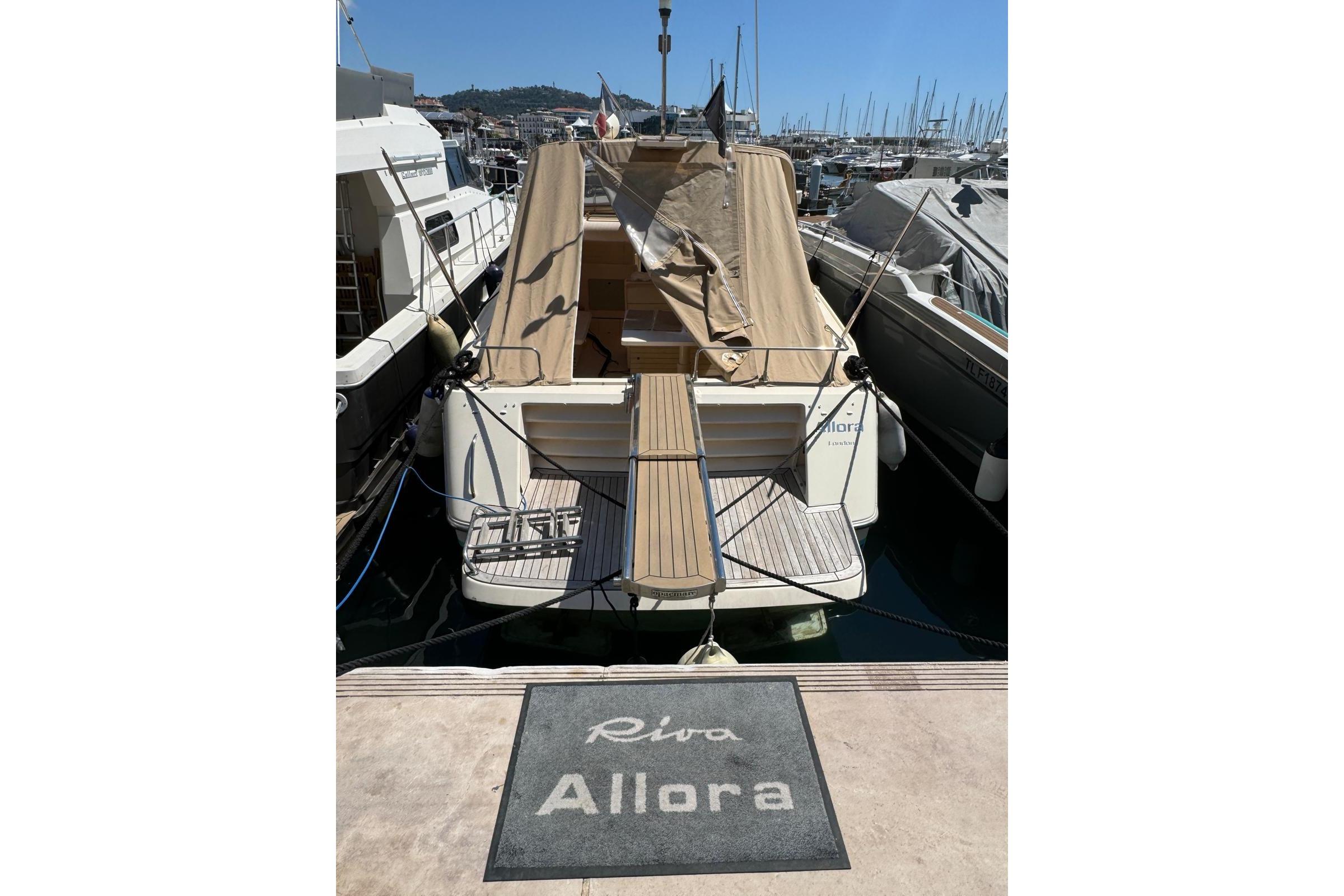 1989 Riva 43' Tropicana yacht docked at marina with protective cover.