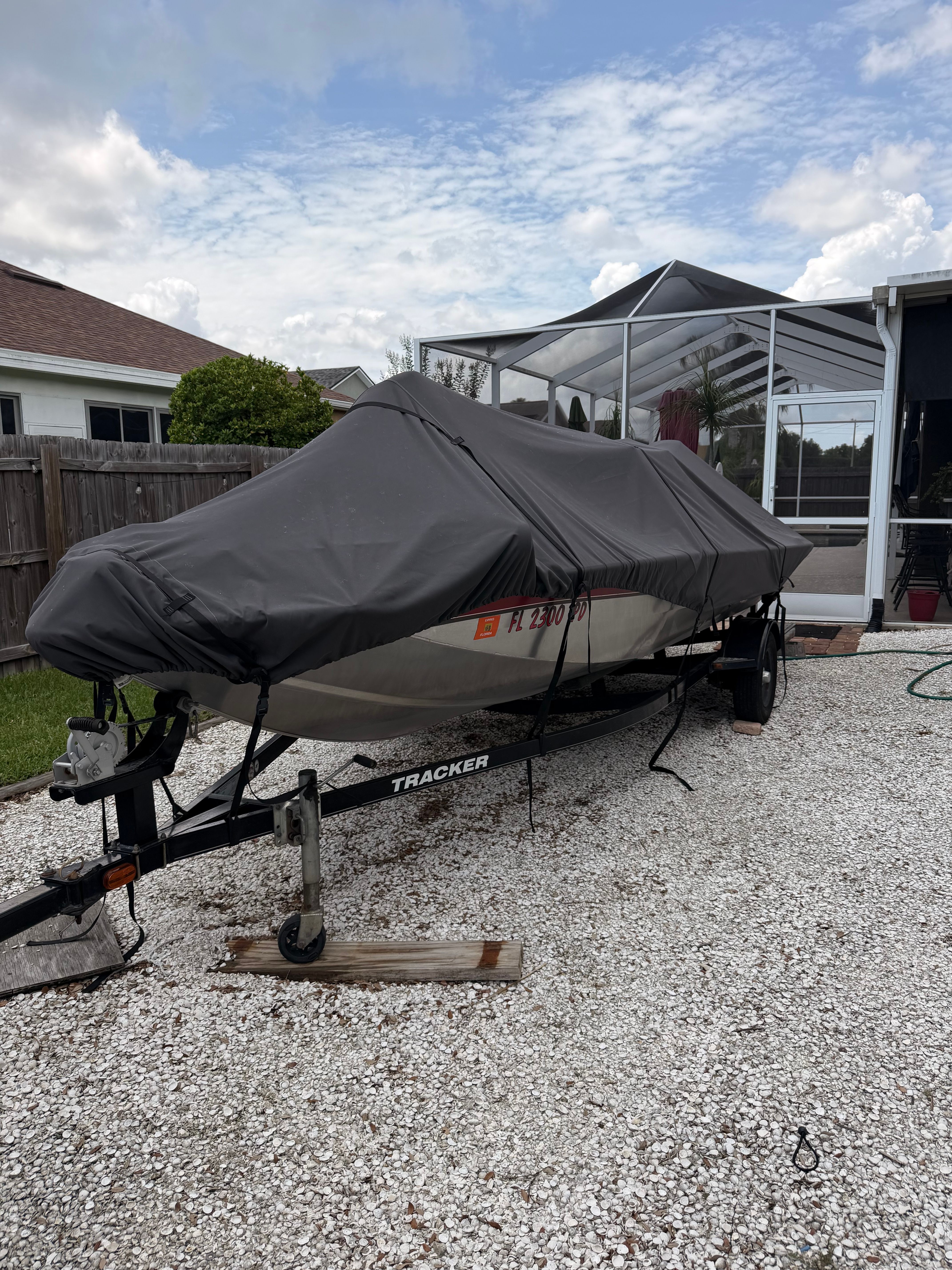 A 2011 Bass Tracker PRO TEAM 175 TXW sits on a trailer outdoors.