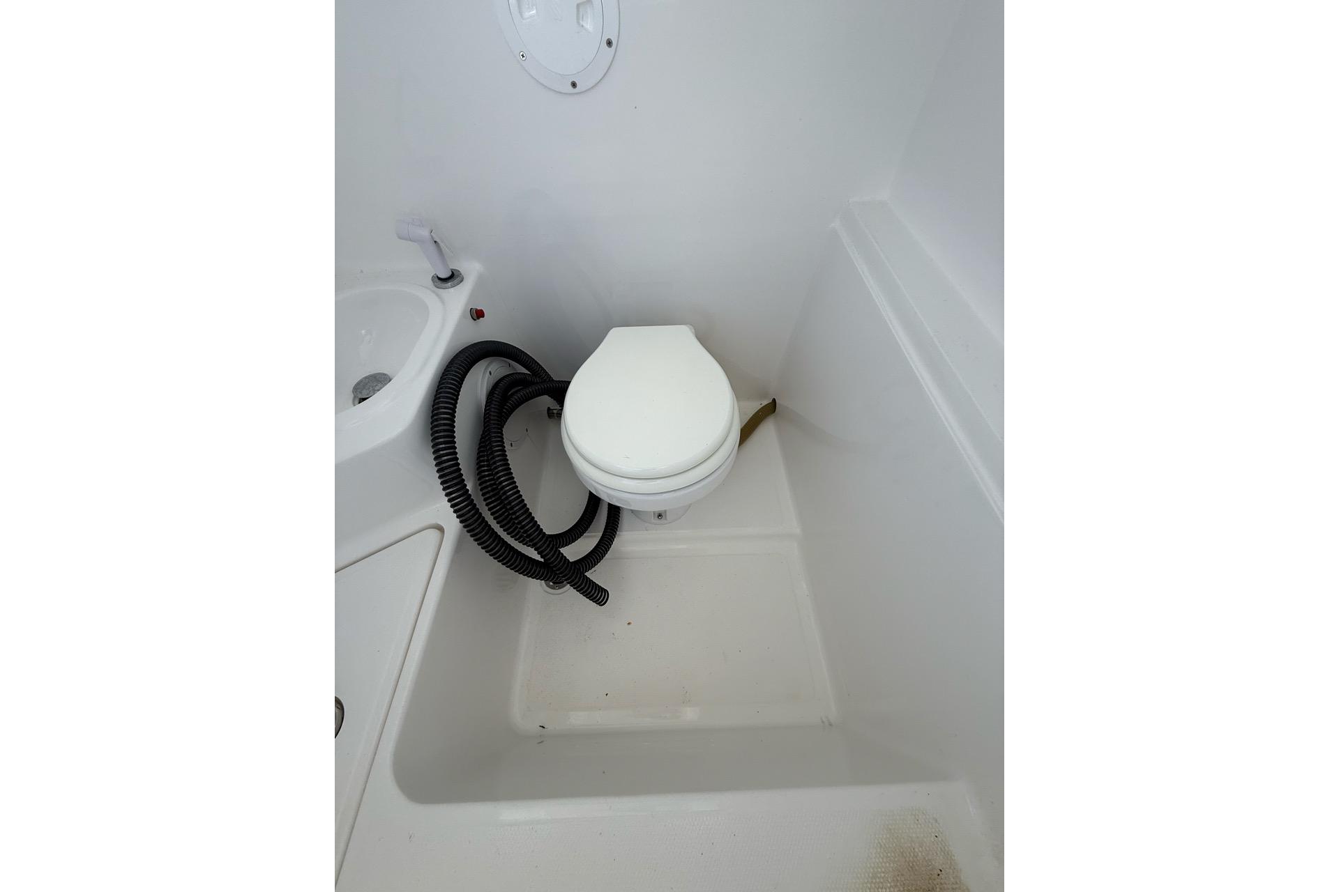 Boat bathroom with toilet and hose, Custom Infusion 34 CC, 2021 model.