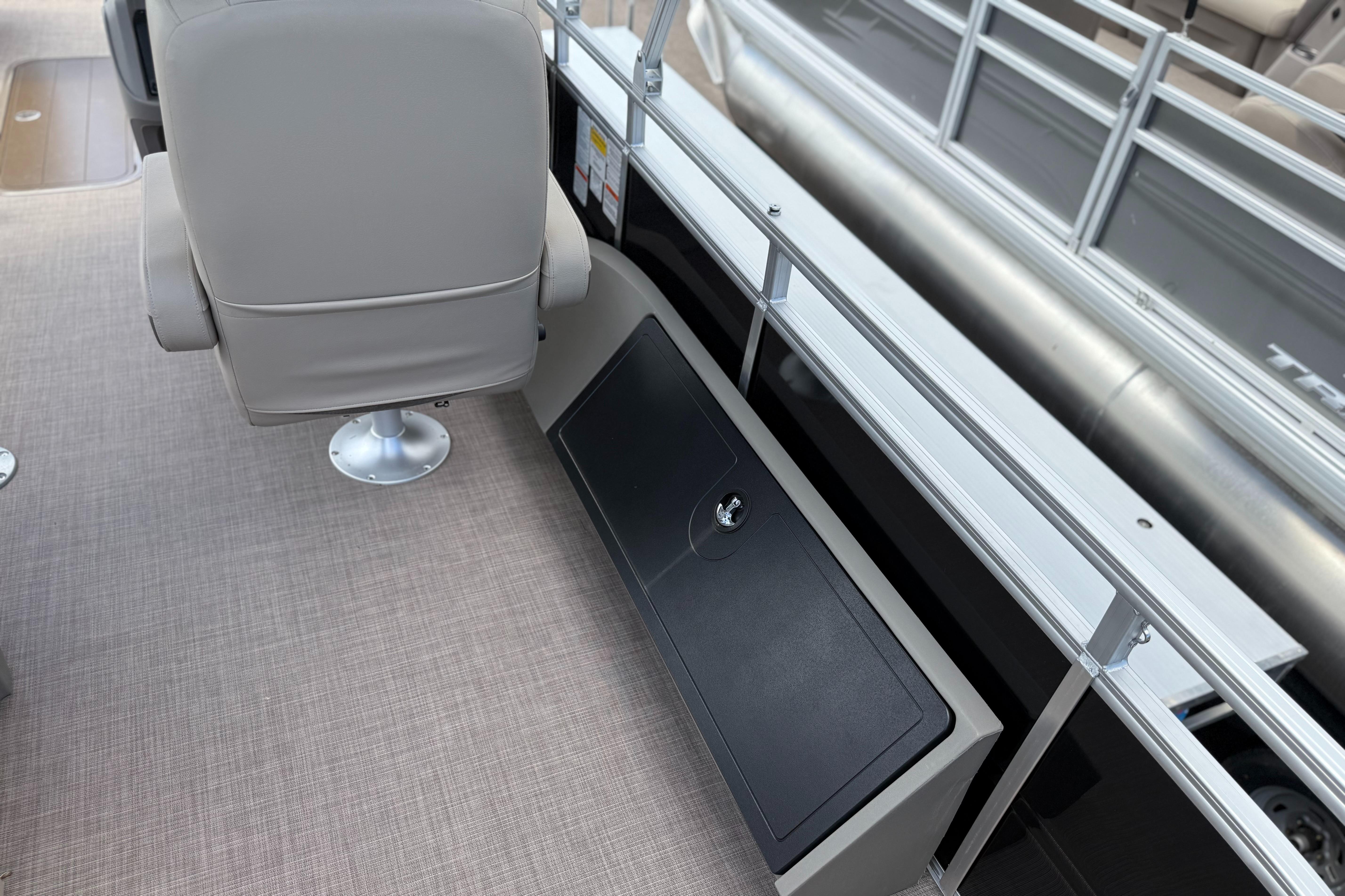 2024 Sun Tracker Sportfish 24 XP3 interior with seating and storage compartment.