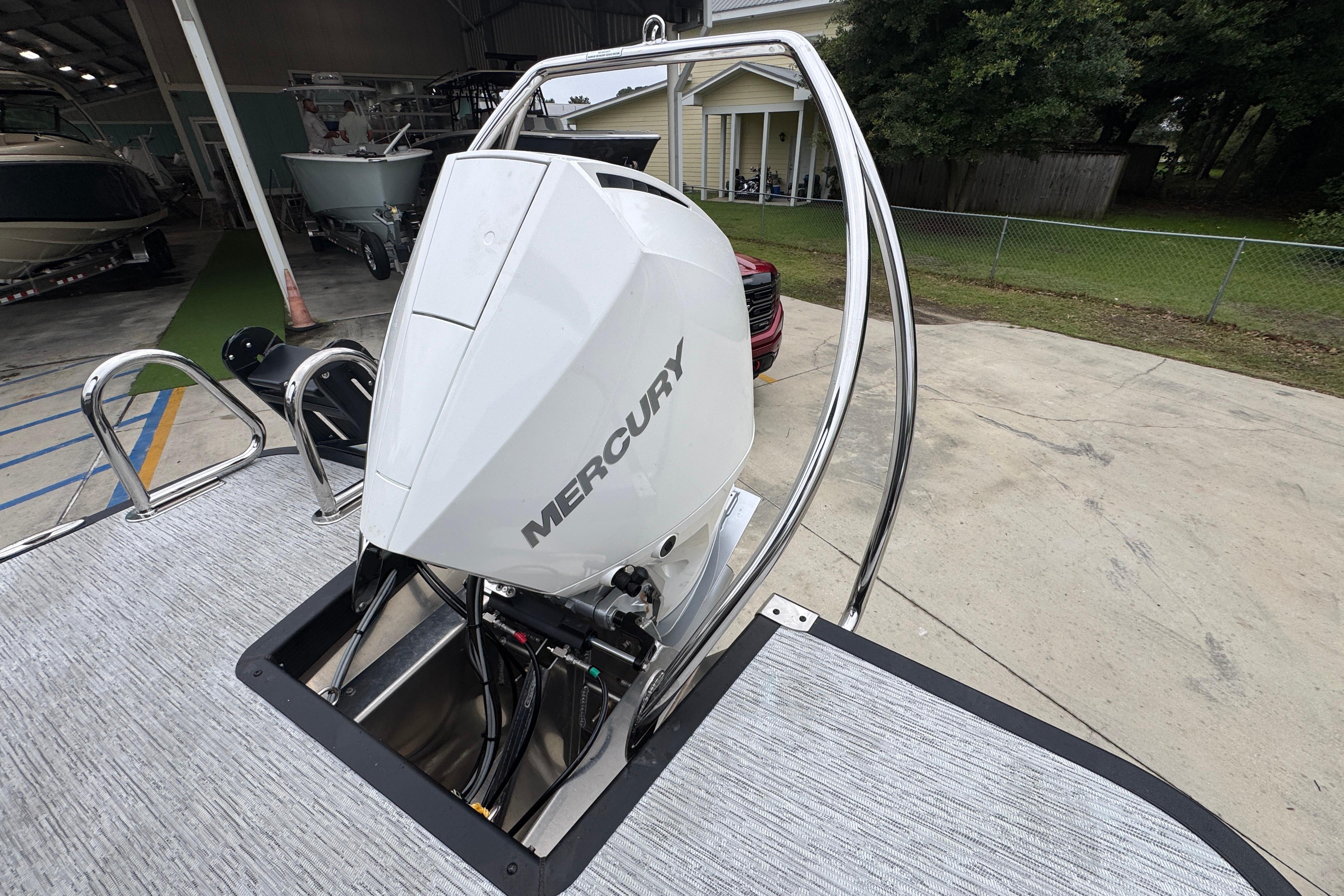 2027 Bennington 24 MFB boat with Mercury outboard motor in a marina setting.
