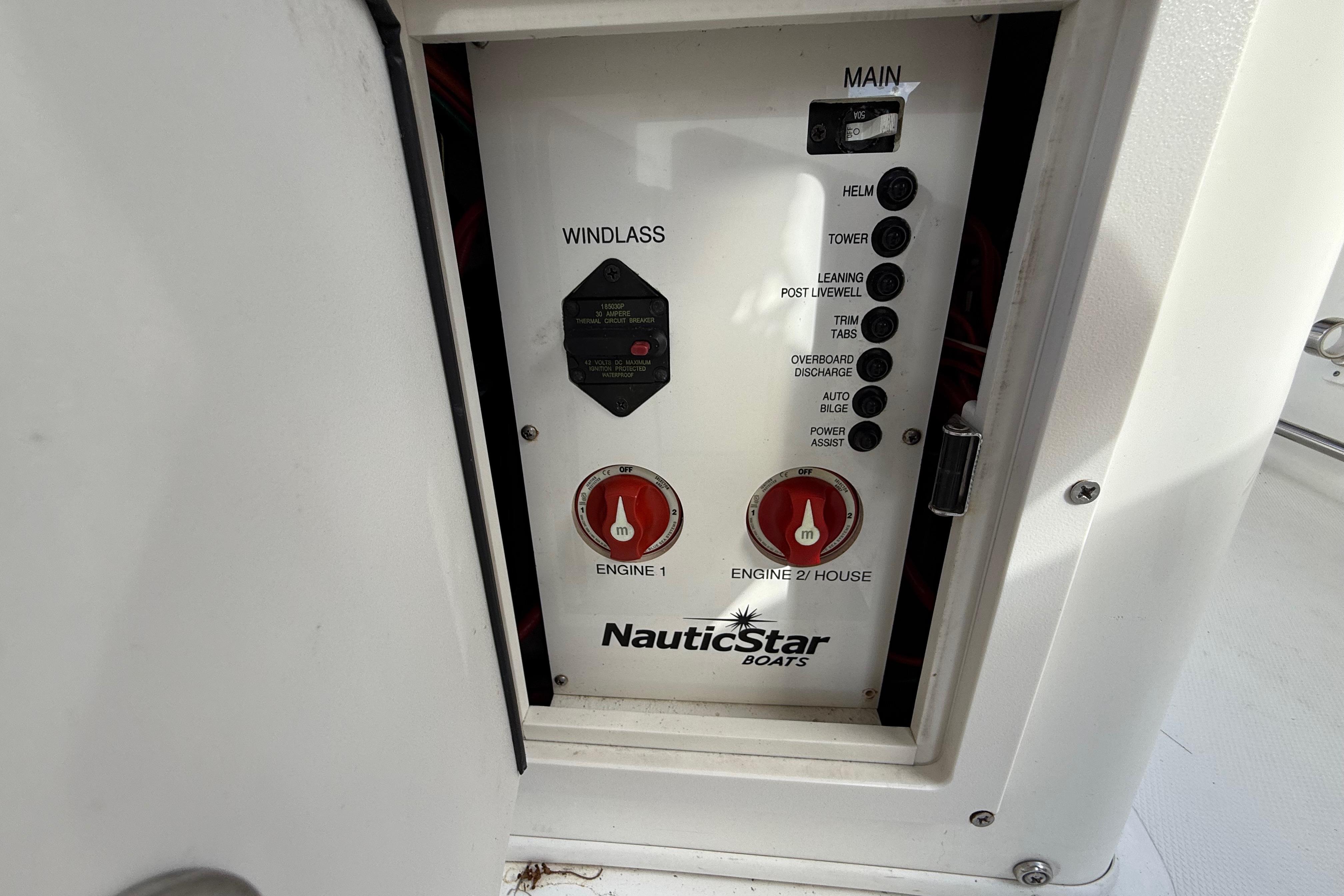 Control panel of a 2018 NauticStar 28 XS boat, featuring engine and windlass switches.