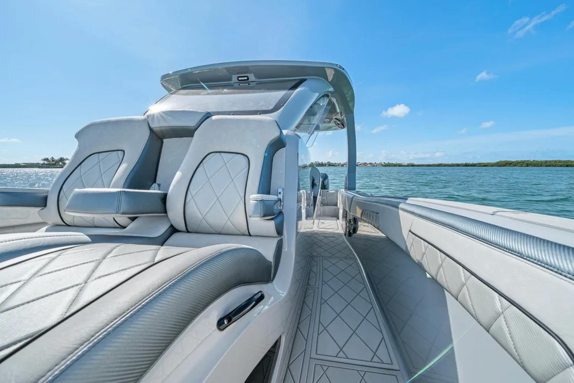 2025 Deep Impact 369 Sport boat interior with luxurious seating on a sunny day.