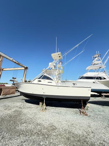 2001 Albemarle 280 Express Sport Fisherman boat on dry dock under clear blue sky.
