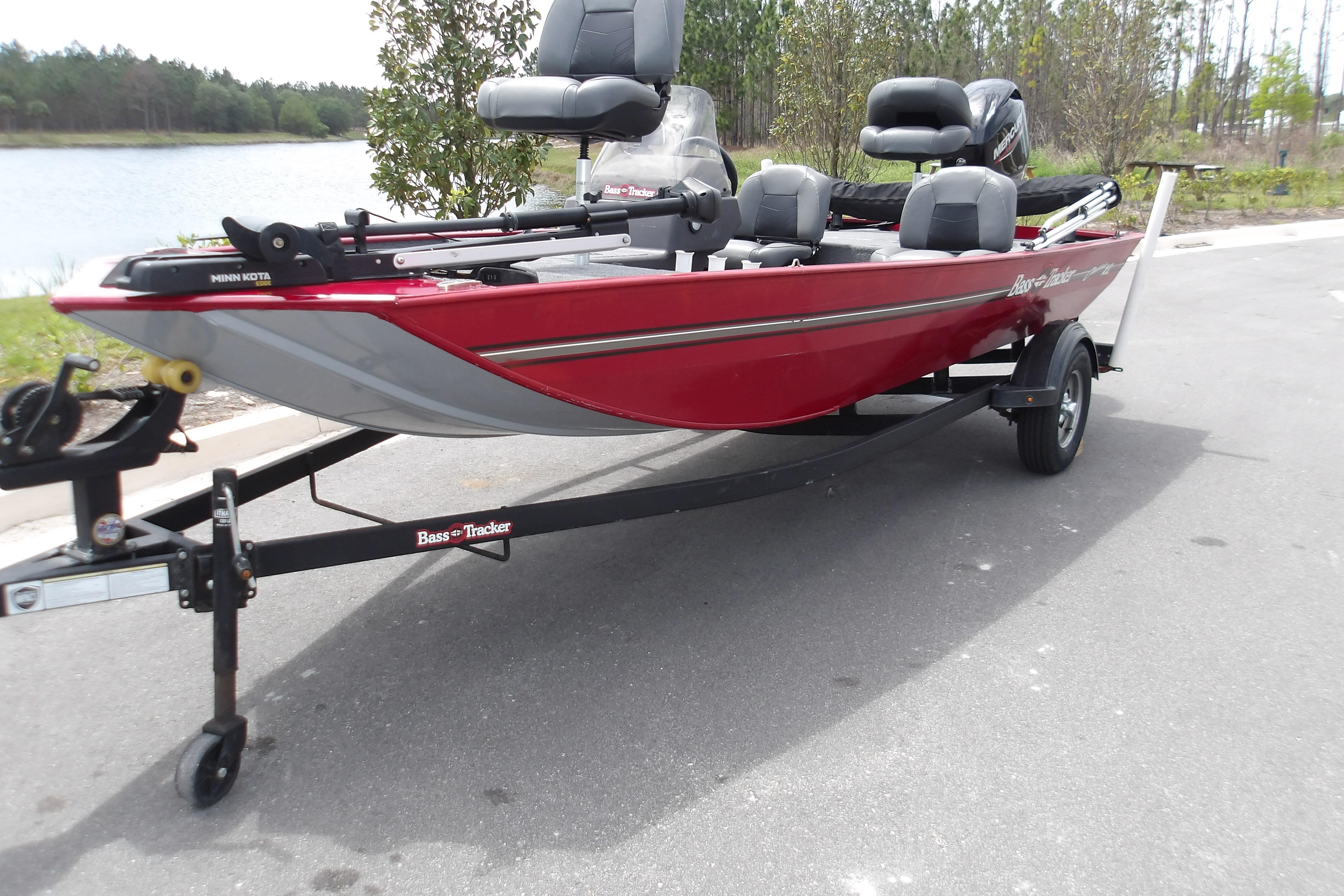 2024 Tracker Bass Tracker Classic XL boat on trailer, parked near a lake.