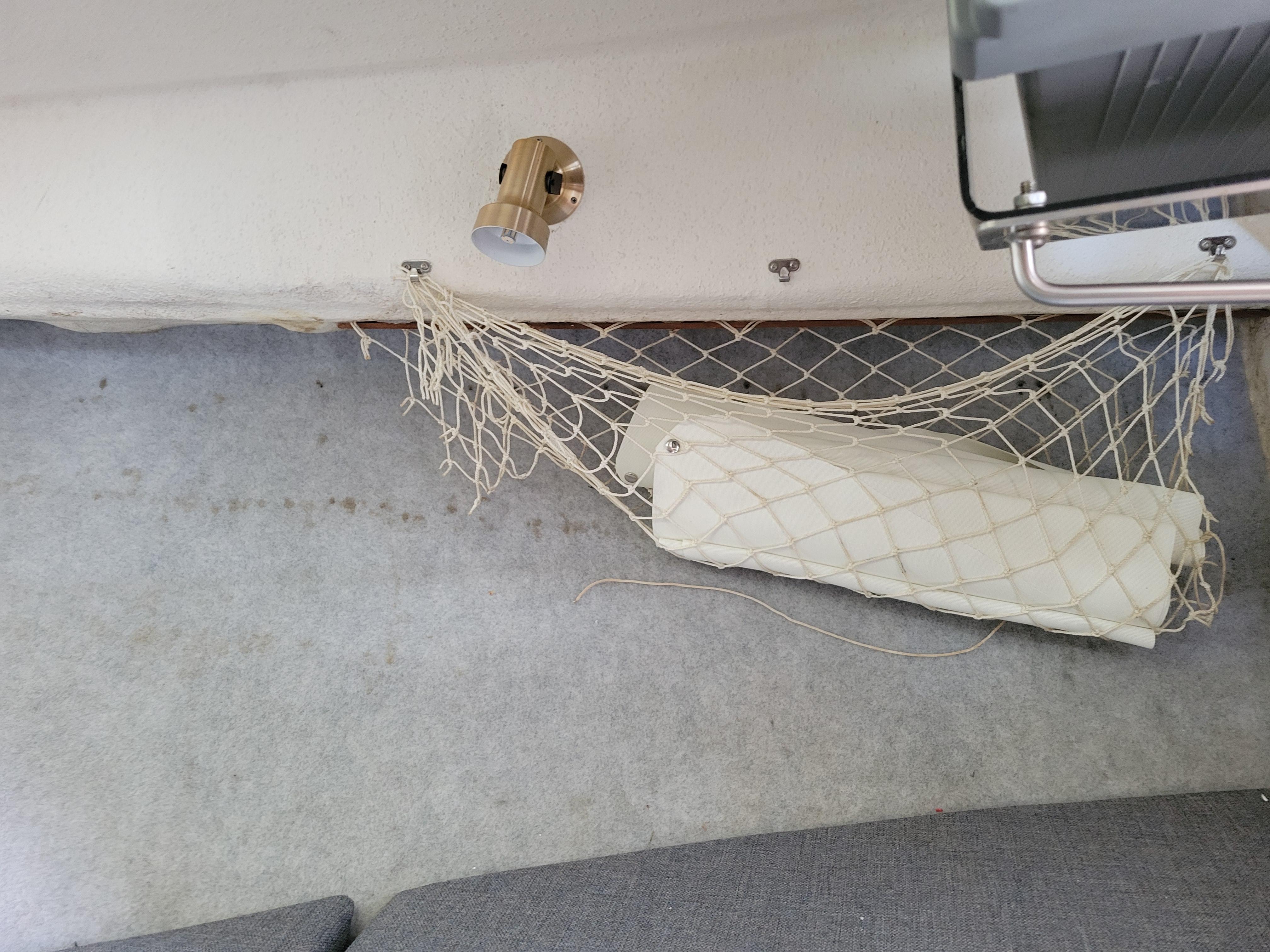 Interior of 1999 SeaSport 2400 XL Limited with netted storage and wall-mounted light.