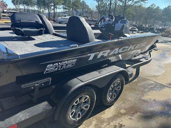 2025 Tracker Savage 215 boat on trailer, parked outdoors, featuring sleek design and dual wheels.