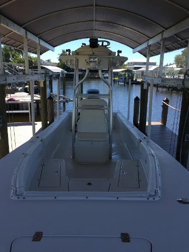 A 2011 Andros 26 Tarpon boat under a covered dock. It features a central console.